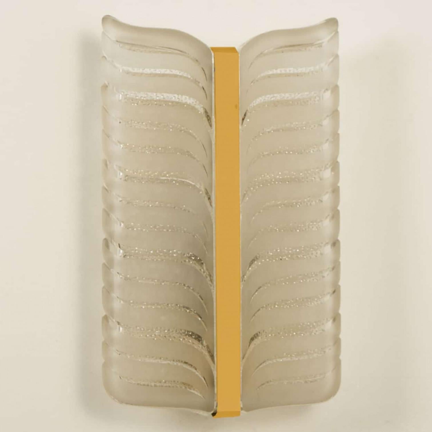 Kalmar leaf wall sconces. Brass center with two panels of glass surrounding both sides.
Thick frosted glass in a leaf pattern.

Minimalistic design executed with a taste for excellence in craftsmanship. Well cleaned respecting the beautiful patina,