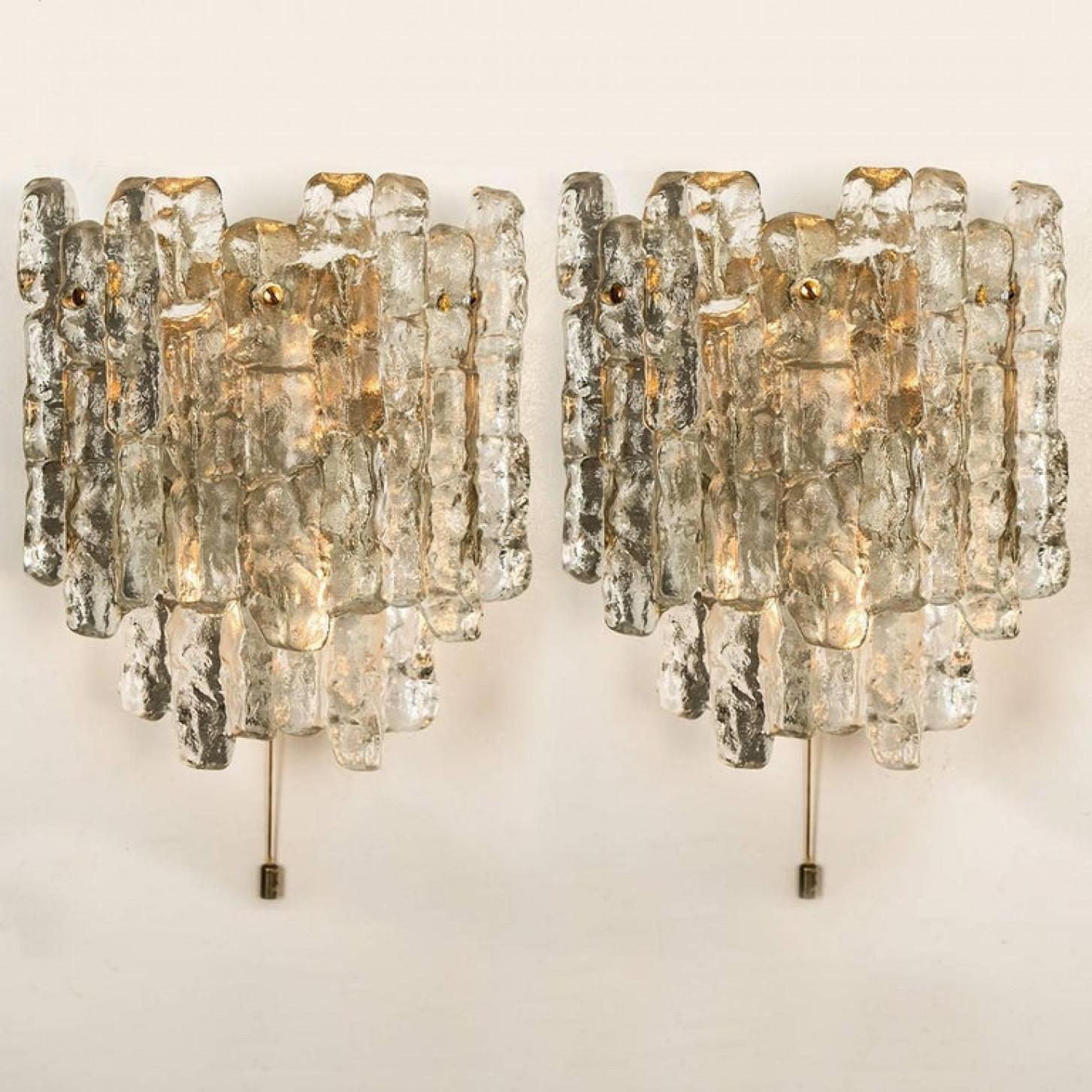 Beautiful and elegant modern brass wall lights or sconces, manufactured by J.T. Kalmar Austria in the 1970s. Lovely design, executed to a very high standard. Each wall light has five solid ice glass sheets dangling on it. Clean lines to complement