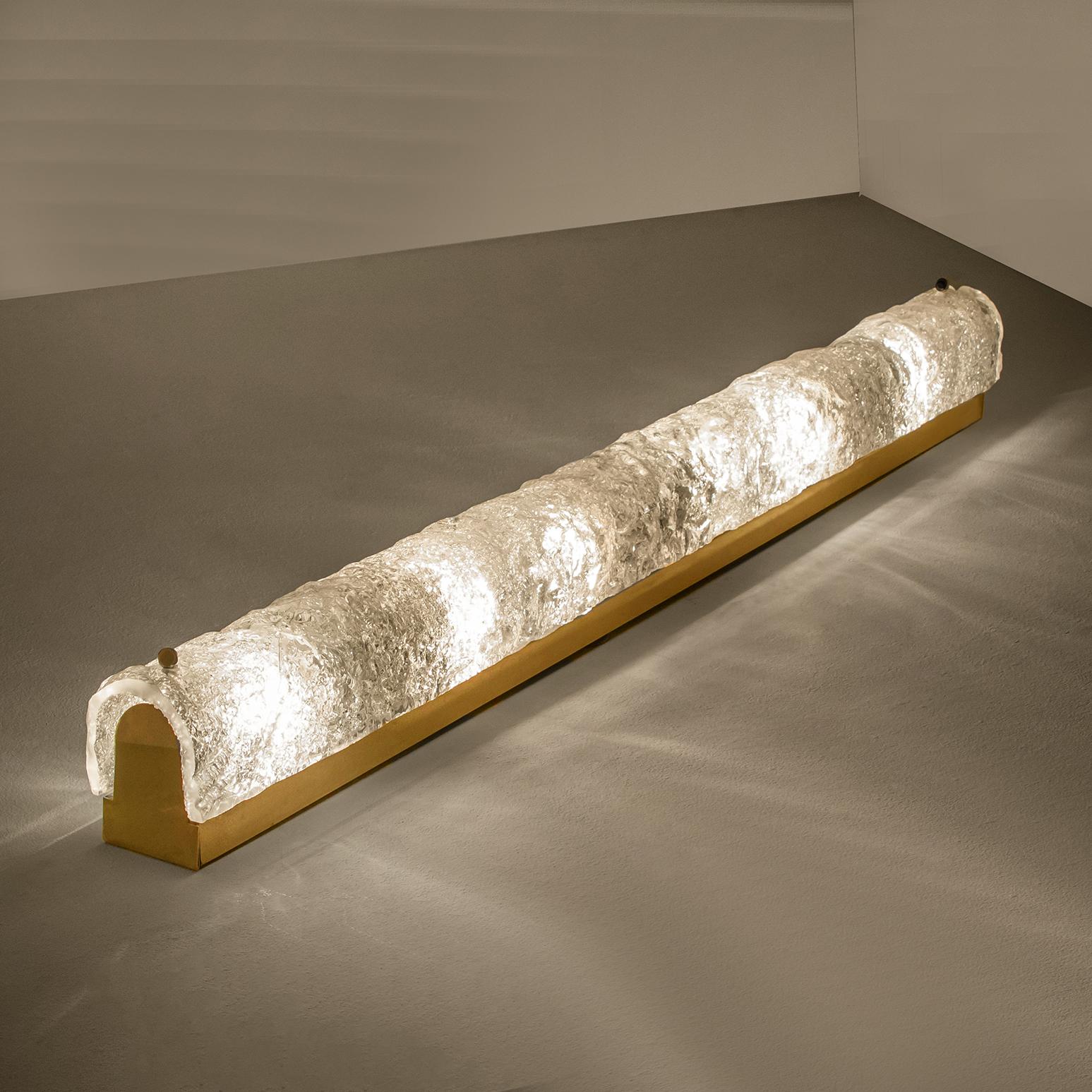 1 0f the 4 large high-end Murano glass on a brass base sconces by Hillebrand, Germany, circa 1960s.
It consists of textured quality clear crystal tubular shade simulating ice on a brass frame.

The design allows this light to be placed either
