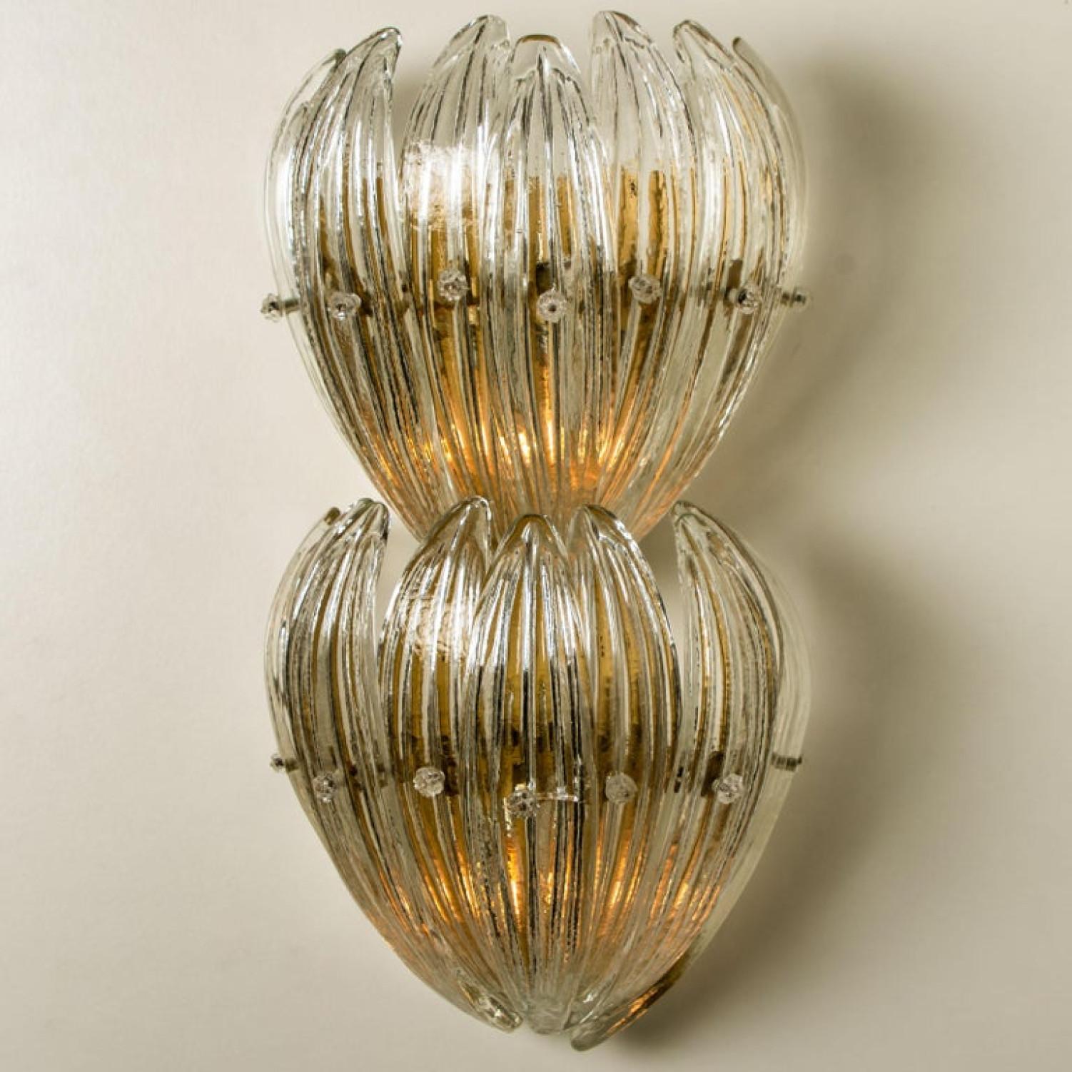 Elegant hand blown murano glass flush mounts of J.T. Kalmar manufactured in the late 1960. The each fixture consists 14 blown murano glass leaves. Mounted on a brass frame. The leaves refract light beautifully. The flush mount fills the room with a