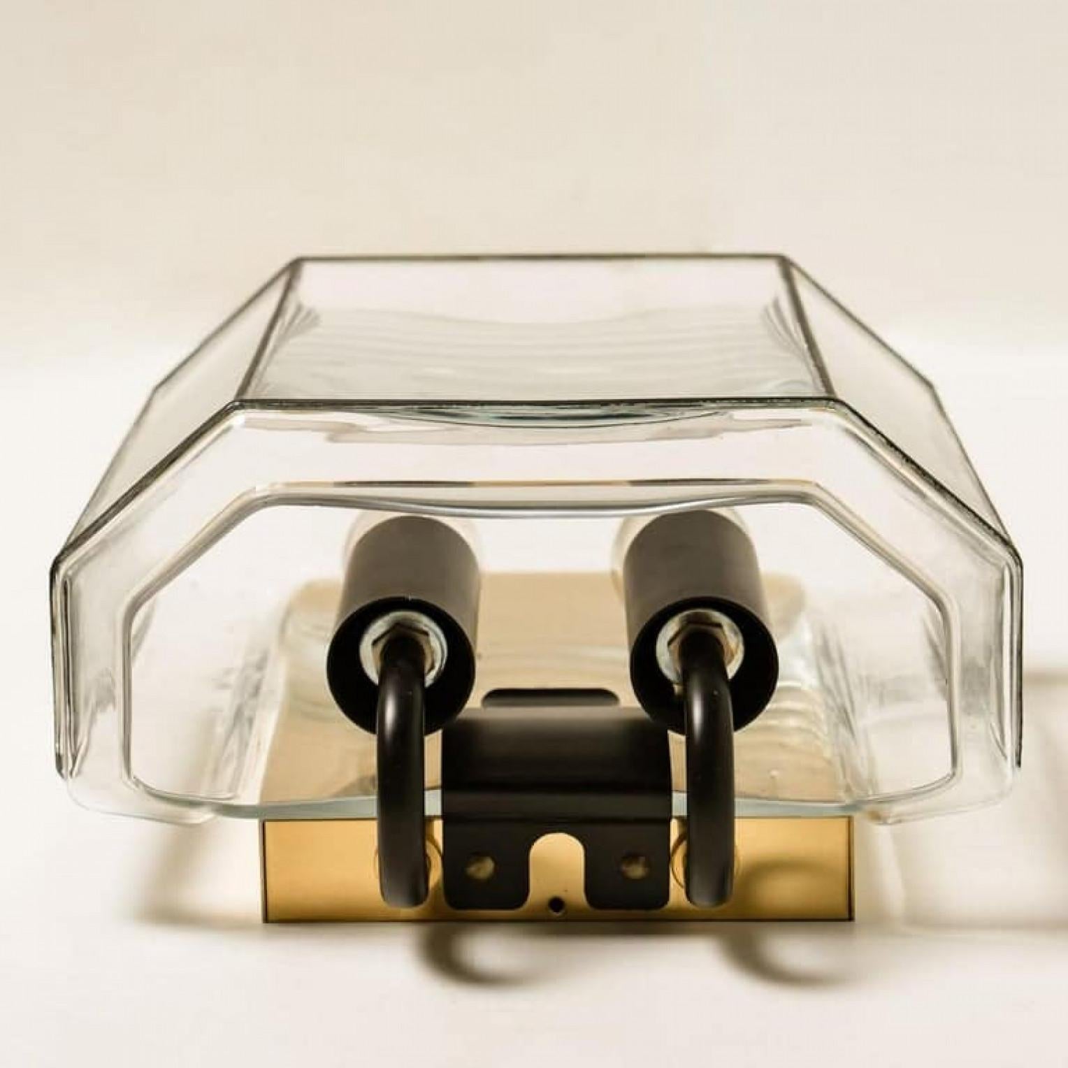 This beautiful and unique pair of hand blown glass wall lights were manufactured by Glashütte Limburg in Germany during the 1960s, (late 1960s or early 1970s).

Beautiful craftsmanship. These mid century vintage lights feature handmade, elaborate