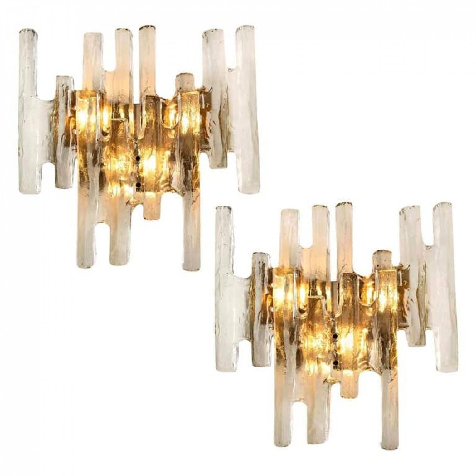 1 of the 4 elegant modern wall lights or sconces, manufactured by J.T. Kalmar Austria in the 1970s. Lovely design, executed to a very high standard. Each wall light as solid ice glass sheets dangling on it.

Clean lines to complement all decors. The