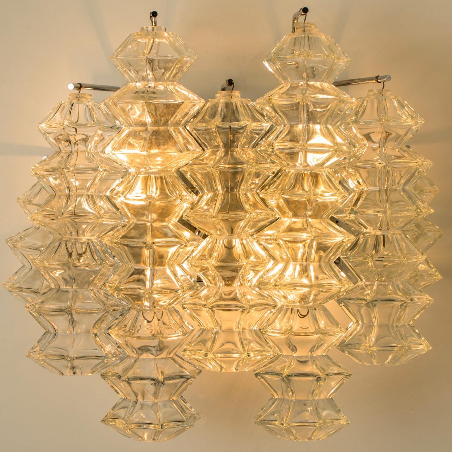 Mid Century Modern vintage glass chrome Pagoda sconces by Kalmar, circa 1969, Austria Vienna.

Each sconce shows 5 exceptional pagoda shaped glasses mounted on a chrome frame.

In excellent vintage condition both glass and brass frame, cleaned