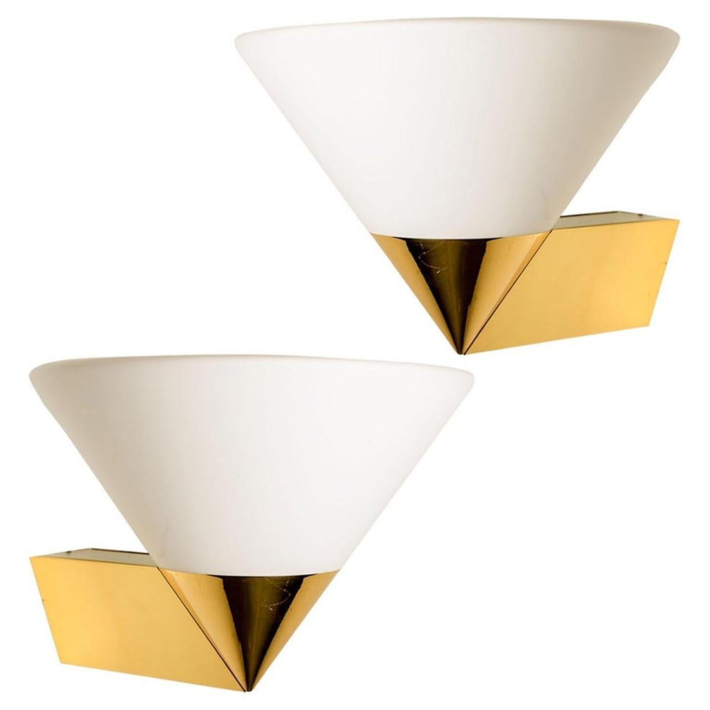 1 of the 4 Pairs Mid-Century Modern wall lamps by Glashütte Limburg made in Germany in the 1970s. They have a beautiful cone shape and are made of solid brass and opaline glass. The the inside is metal.

Dimensions Height: 15.4 in. (39 cm) Width: