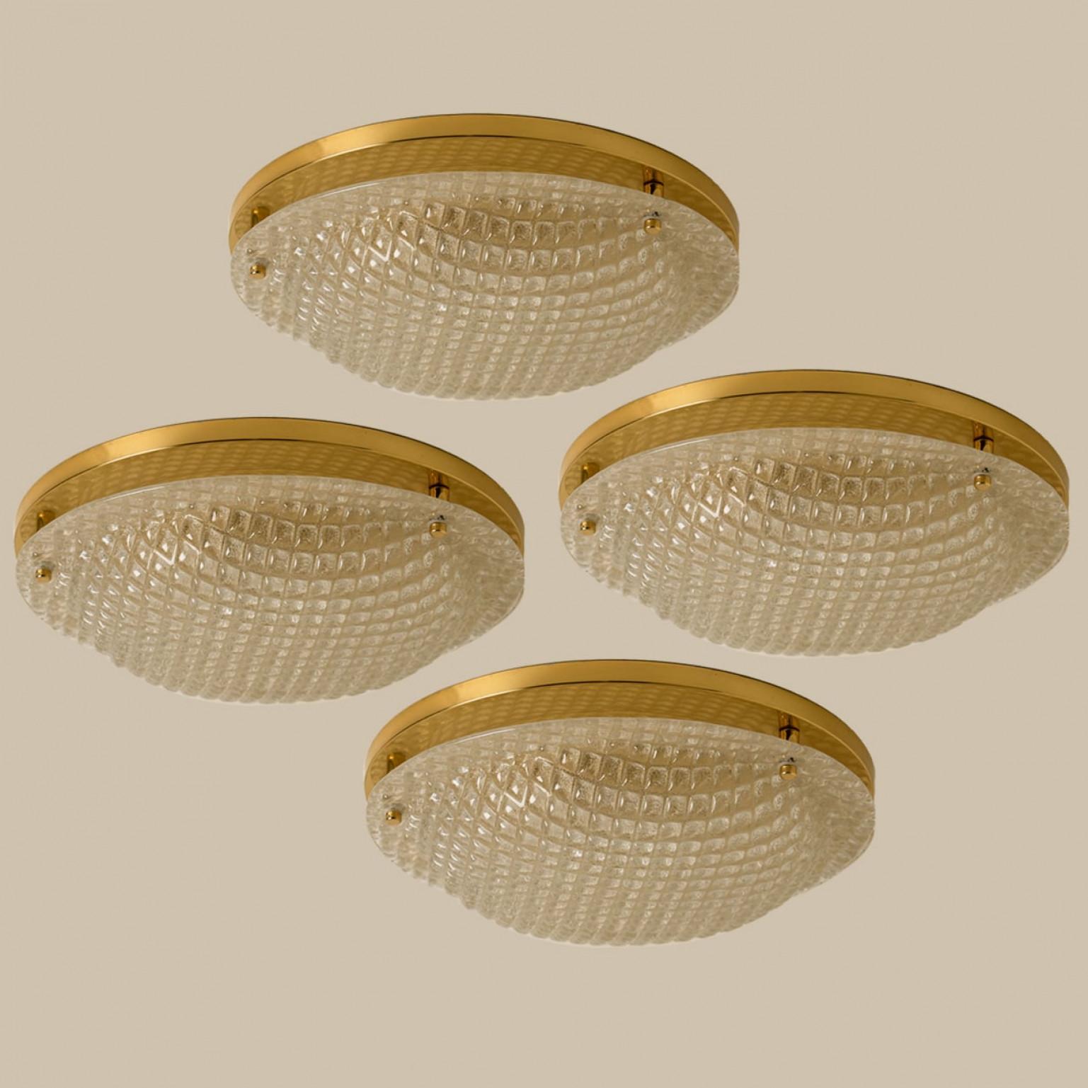 A high quality modern textured ice glass flush mounts by Hillebrand, circa 1965.
This flush mount is featuring a huge round hand blown glass dish with blocked pattern. Beautiful craftsmanship.

Can also work for impressive wall light. 4 pieces
