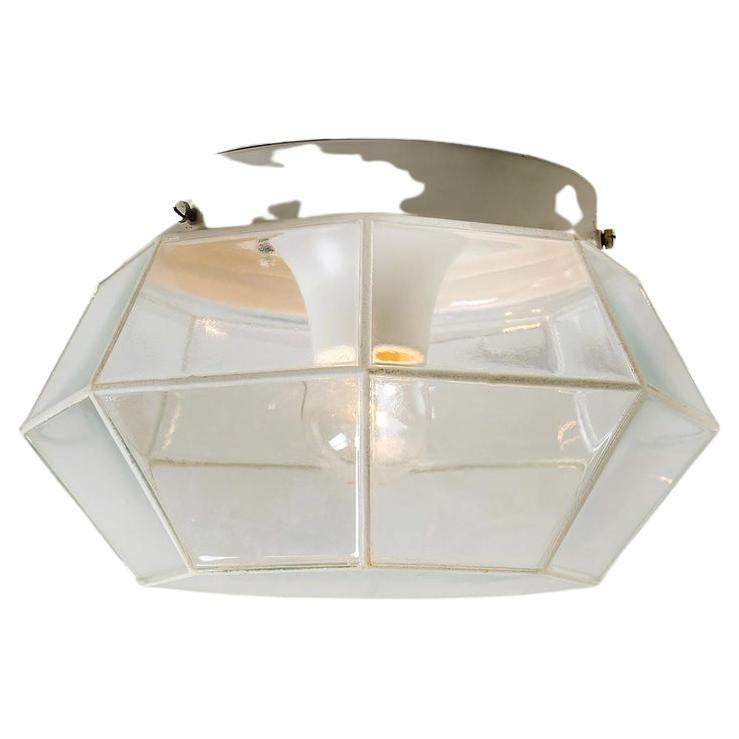 Minimalist iron and clear glass flush mount manufactured by Limburg Glashu¨tte Germany, circa 1960-1969. Octagonal shaped lantern and multifaceted clear glass.
Illuminates lovely

Dimensions
Diameter: 11 in / 28 cm Height: 7 in / 18
