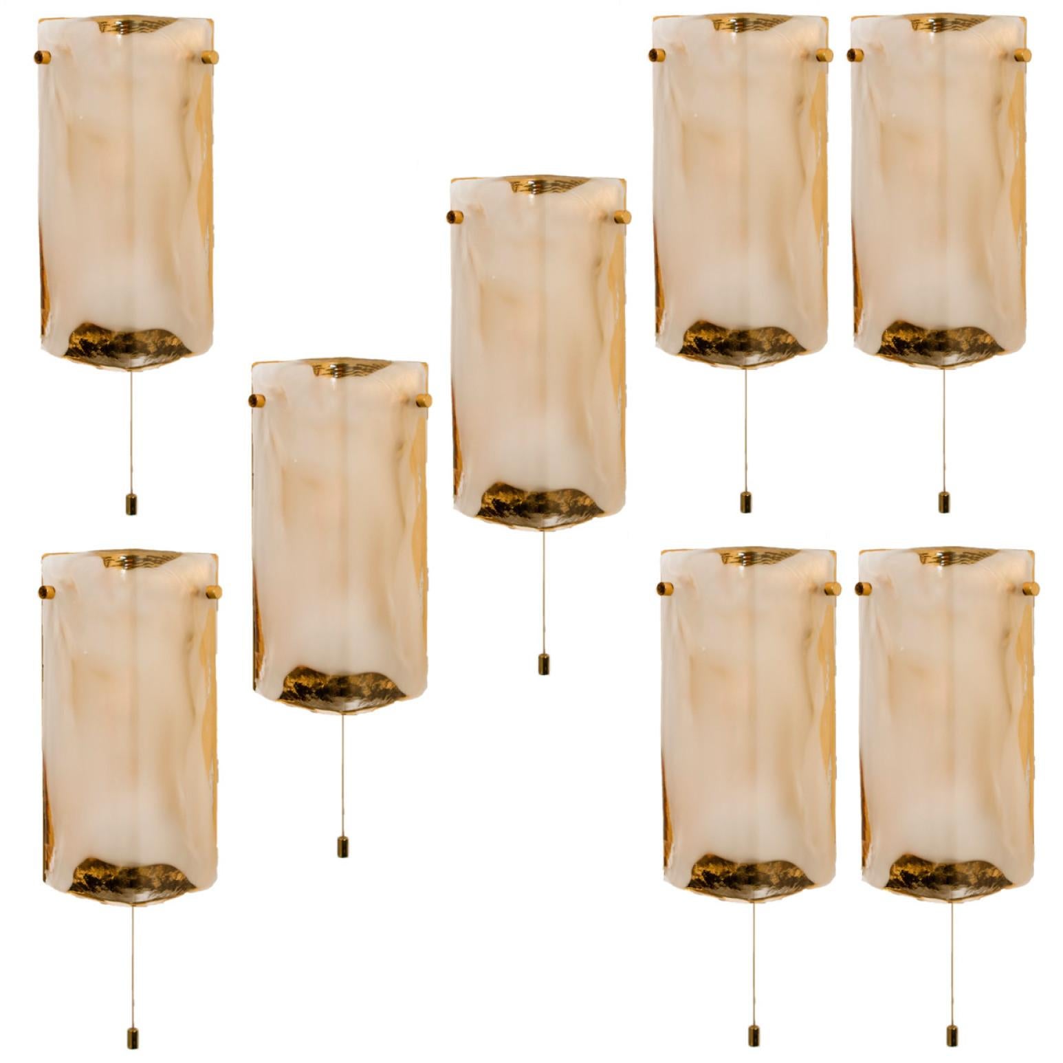 Pair high-end wall sconces made of hand blown clear and white Murano glass on a brass hardware designed and produced by J.T. Kalmar, Austria in the 1960s. Minimalistic design executed with a taste for excellence in craftsmanship. Statement