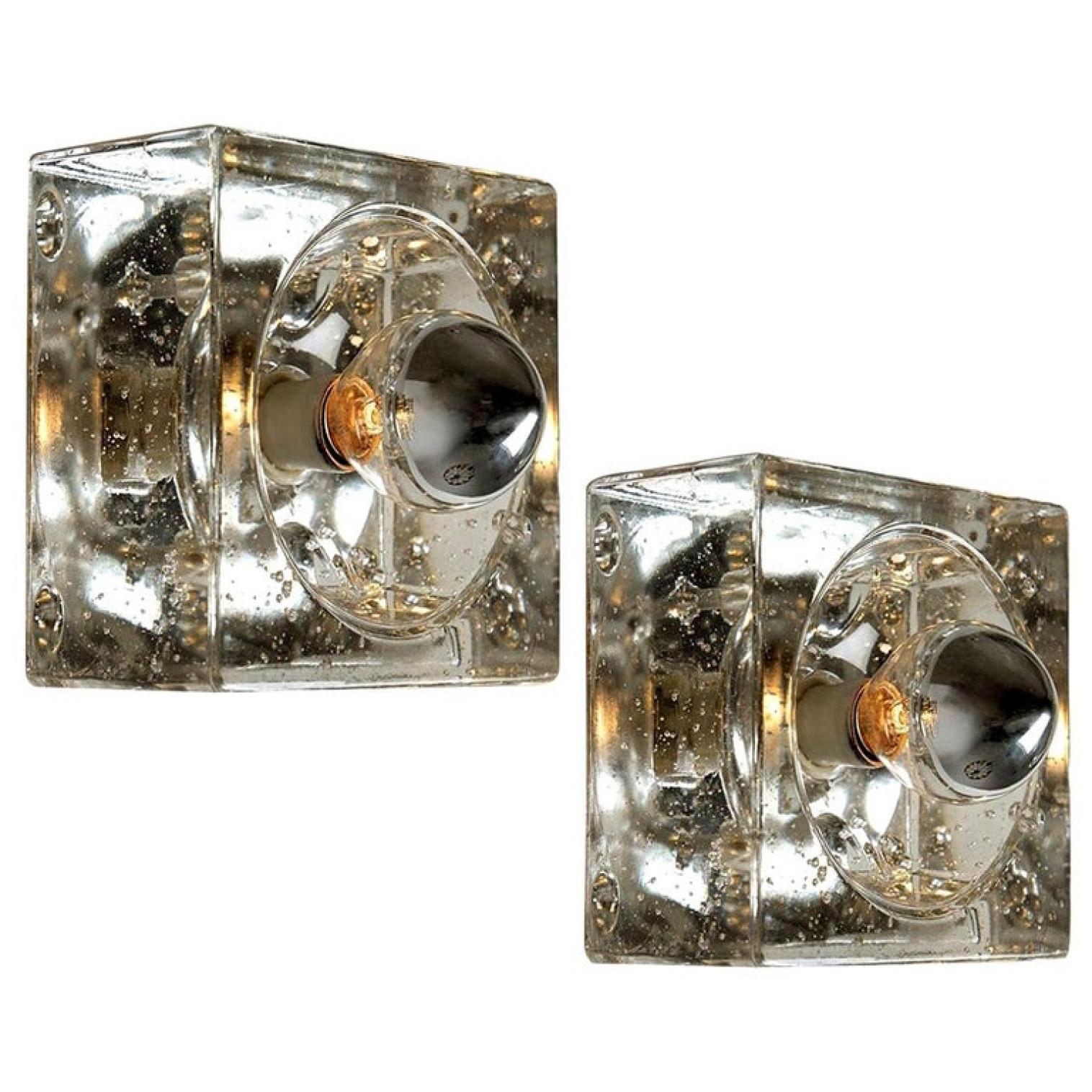 This lights are made from thick hand blown glass on a square silver colored backplate. The glass causes a nice lighting effect on the ceiling or wall. Each lamp has one E14 fitting (Max 25 Watt)

Can work for impressive wall or ceiling lights.
We