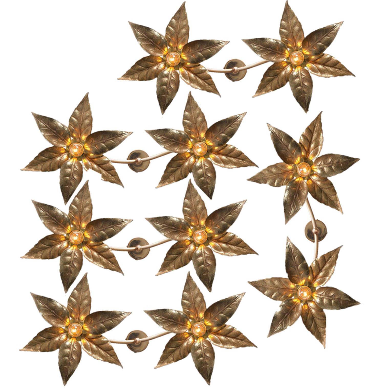 One of the five brass flowers wall sculptures in the style of designer Willy Daro manufactured by 'Massive Lighting', circa 1970s, Belgian. This decorative and beautiful large sculptural light consists of a pair of brass-plated flowers on a bar and