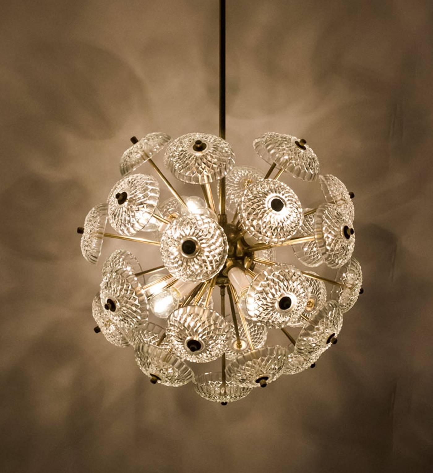 Set of max 5 stunning large brass chandeliers in style of Emil Stejnar. Made of brass with stylish glass disc glass light diffuses. The art glass gives a nice diffuse light effect and a nice pattern on ceiling, walls and floor. 

Each Sputnik has