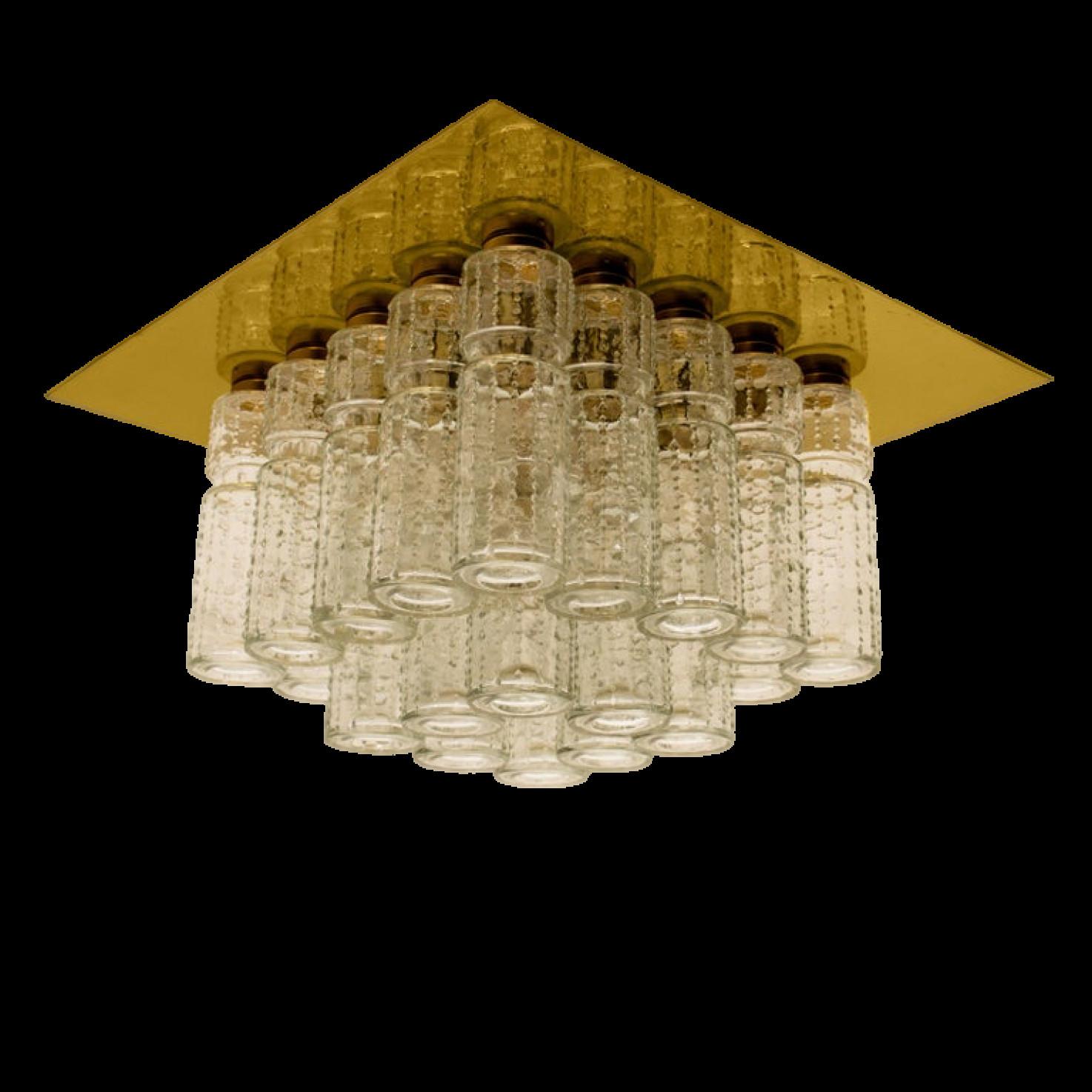 One of the six amazing flush mount chandeliers with 24 hanging hand blow textured hollow glass prisms mounted on a brass frame. Made by Glashütte Limburg in Germany designed by Boris Tabacoff in the 1970s. High end light fixtures from the 20th