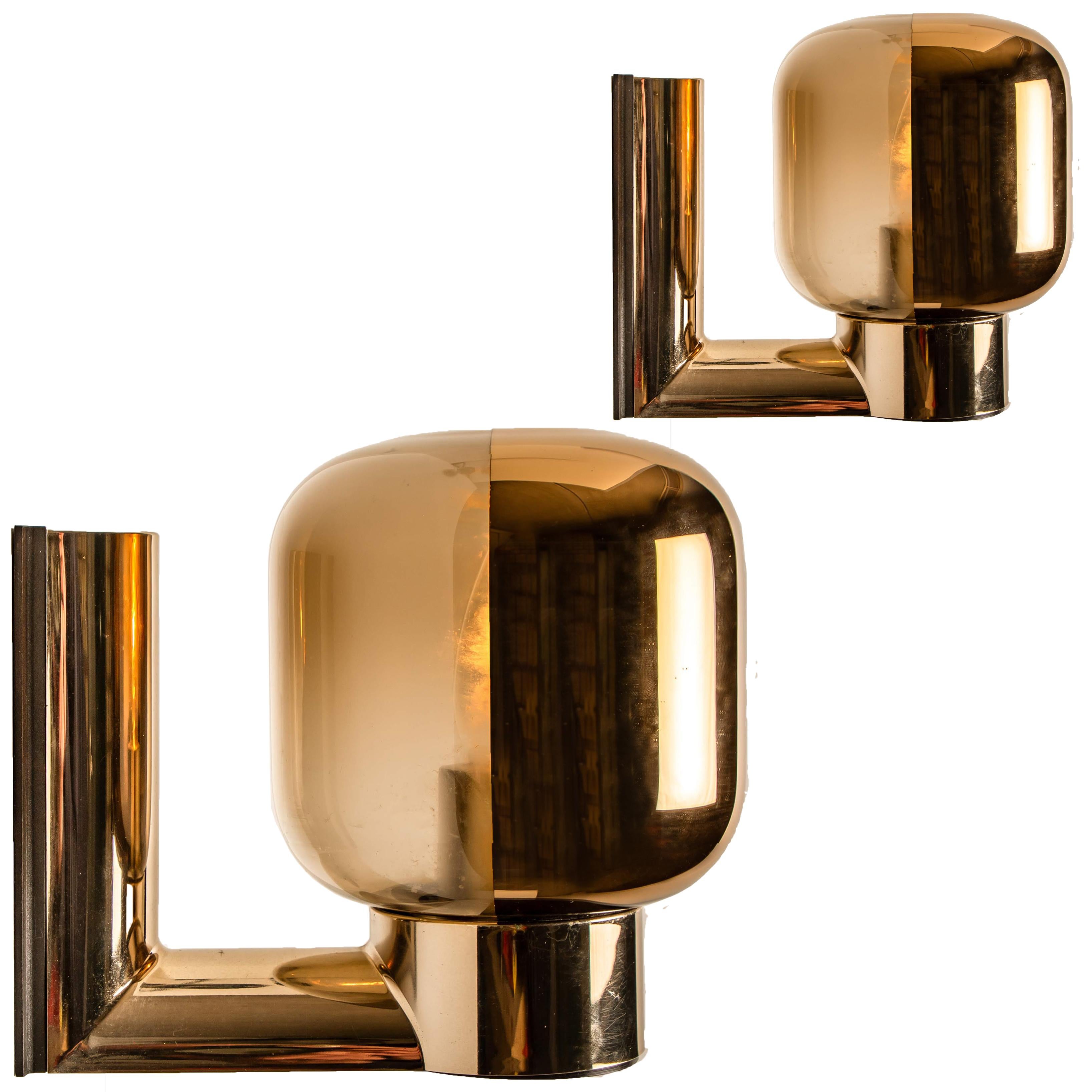 One of the six amazing wall sconces manufactured by Staff made of smoked glass, synthetic material and brass. It is possible to switch the light bowl in another position for a different light direction.

Very heavy quality, in good vintage