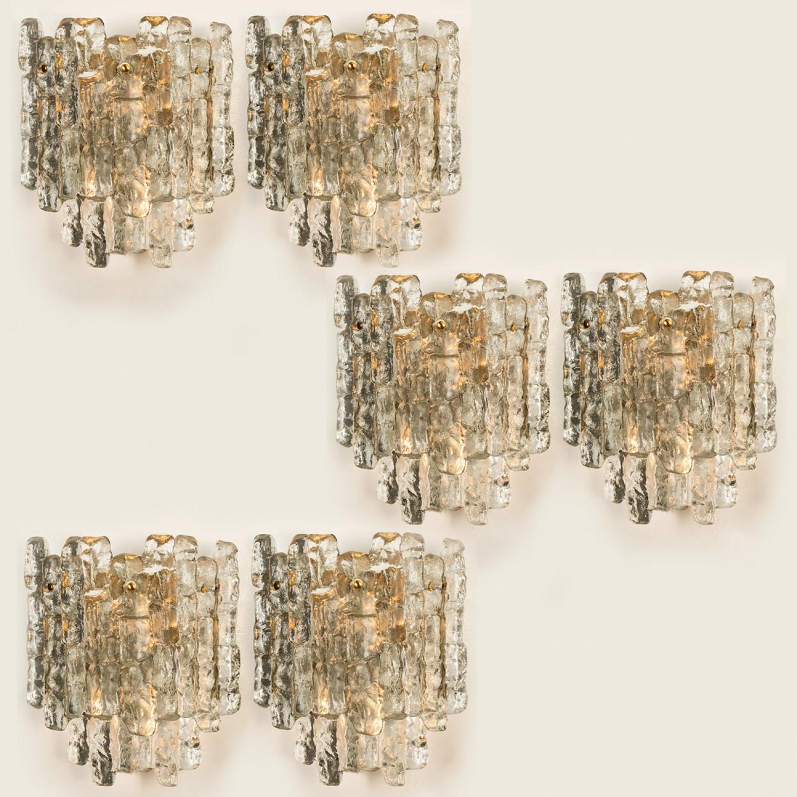Beautiful and elegant modern brass wall lights or sconces, manufactured by J.T. Kalmar Austria in the 1970s. Lovely design, executed to a very high standard. Each wall light has five solid ice glass sheets dangling on it. Clean lines to complement