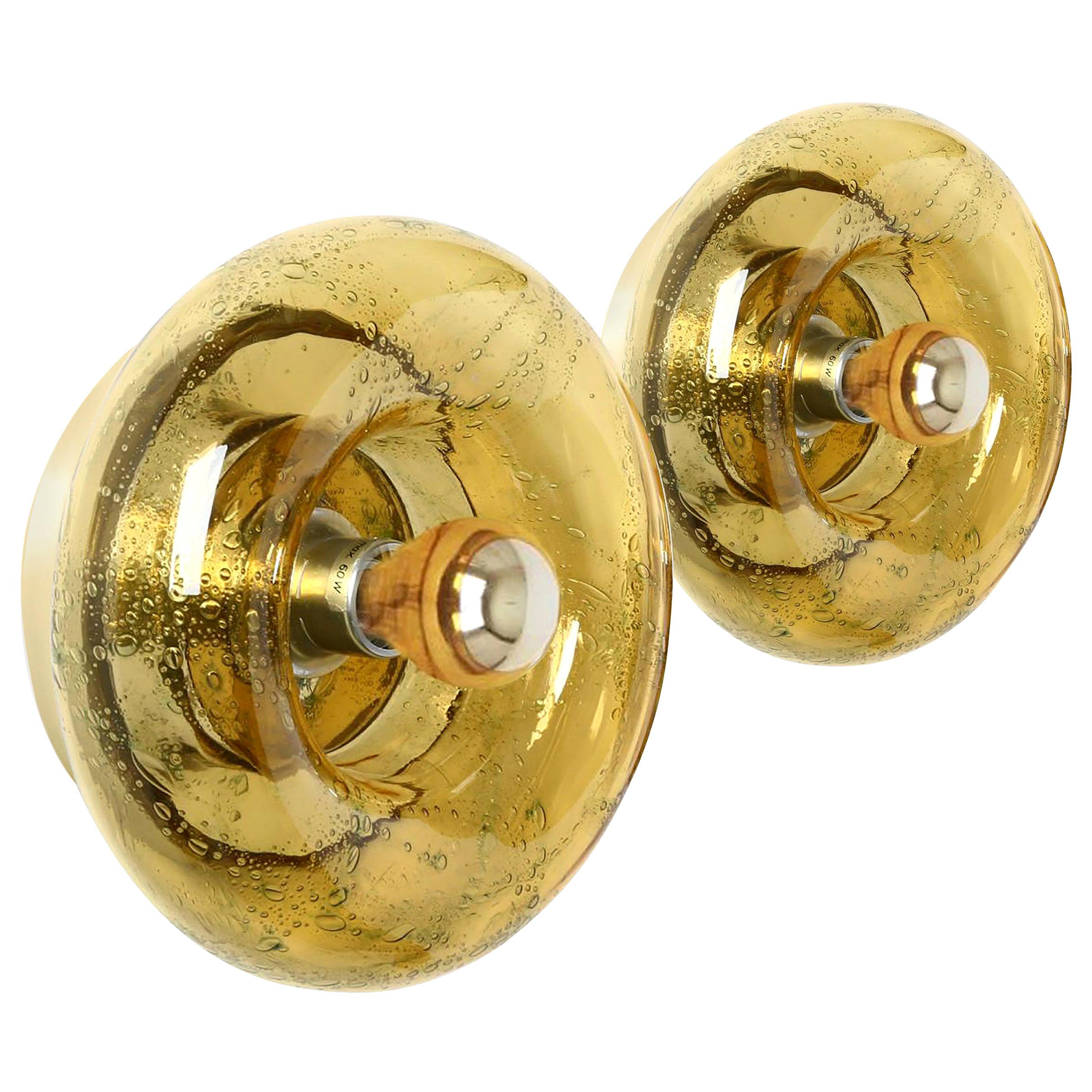 Wonderful 20th century Murano wall sconces which can also be used as ceiling fixture. Manufactured in the 1960s. It is made of amber colored glass and brass end metal.

Two sizes available: four 10.6 inch (27 cm) and two 8.7 inch (22 cm)

Very