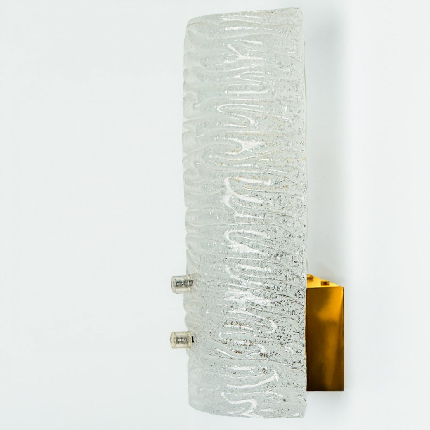 One of the six Beautiful and elegant modern brass wall lights or sconces, manufactured by J.T. Kalmar Austria in the 1960s. Lovely design, executed to a very high standard.

Each light has one ribble textured glass column on it. Clean lines to