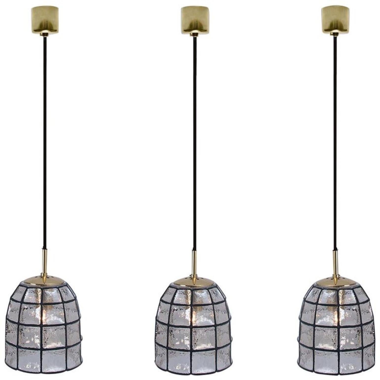 This beautiful set octagonal glass light fixtures were manufactured by Glashütte Limburg in Germany during the 1960s. Beautiful craftsmanship. Each lamp, made from thick elaborate clear glass with rectangular black accent elements features one E27