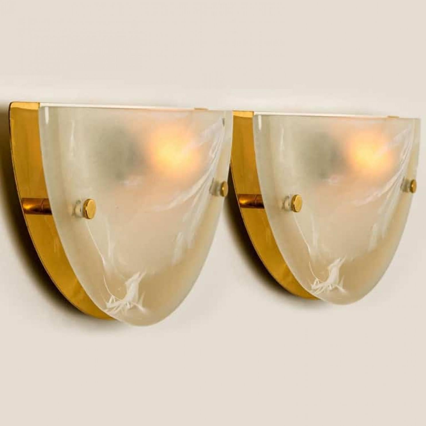 1 of the 8 high quality modern thick textured ice glass flush mount or wall lights by Hillebrand, circa 1975.
Each light fixture is featuring a huge round blown half glass dish. Minimalistic design executed with a taste for excellence in