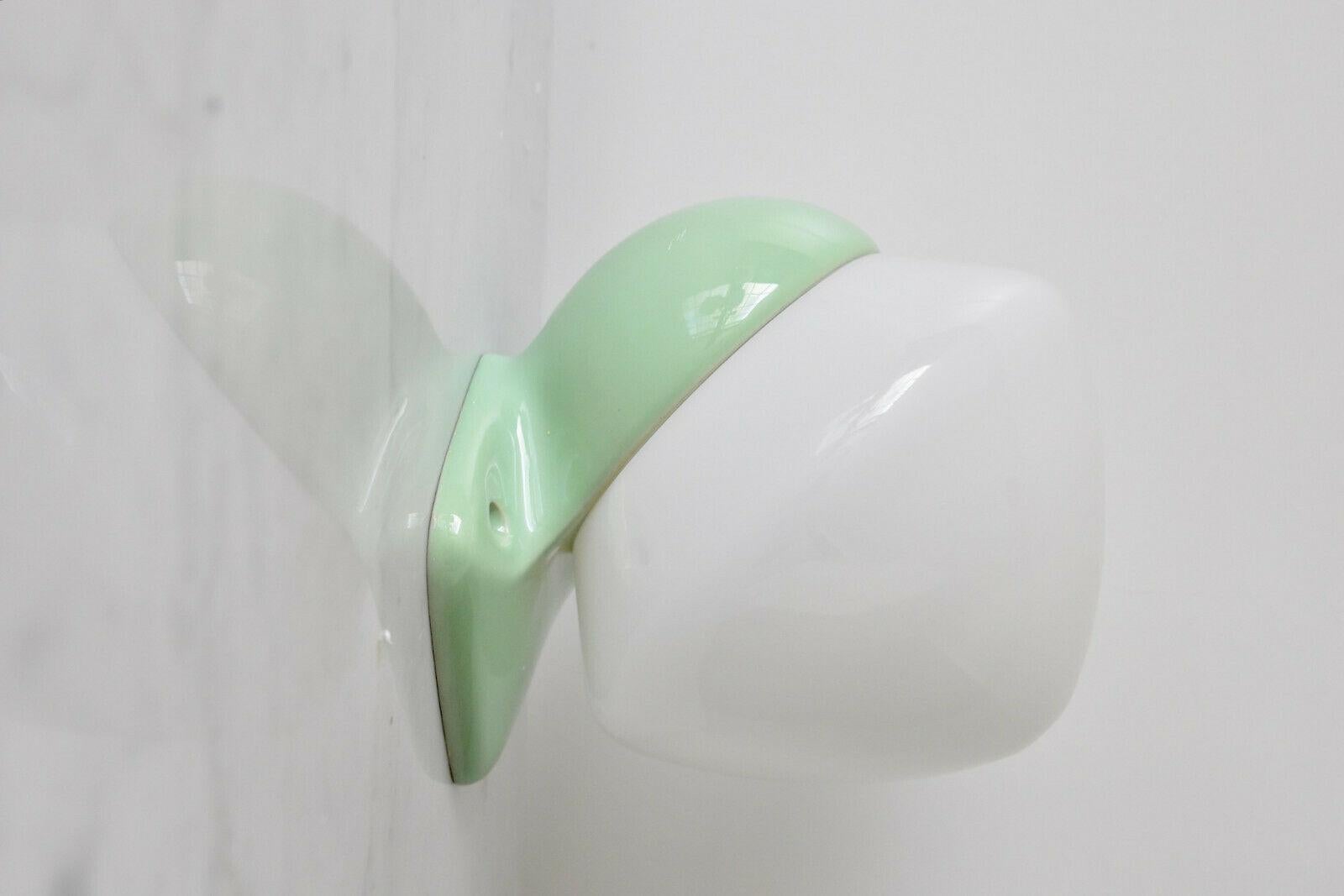 Nice vintage wall lamp design by Sigvard Bernadotte manufactured by infö Electric in 1950s Sweden. Opaline glass with porcelain socket. With E27/26 Edison screw socket (ready to use worldwide) in very nice condition. Ready to use with 110 or 250