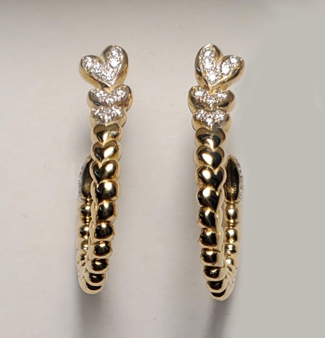 1 Pair of Earrings 14k yellow gold Earrings with Diamonds are hearts that spiral around 
stones: 30 diamonds 
color: G
clarity: VS
weight: .17pts.
gold: 14k
*Peggy Croft is hand wax carver of fine jewelry with details of no other and has been