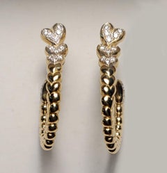 1 Pair Earrings 14k yellow gold Earrings with spiraling Diamonds Hearts
