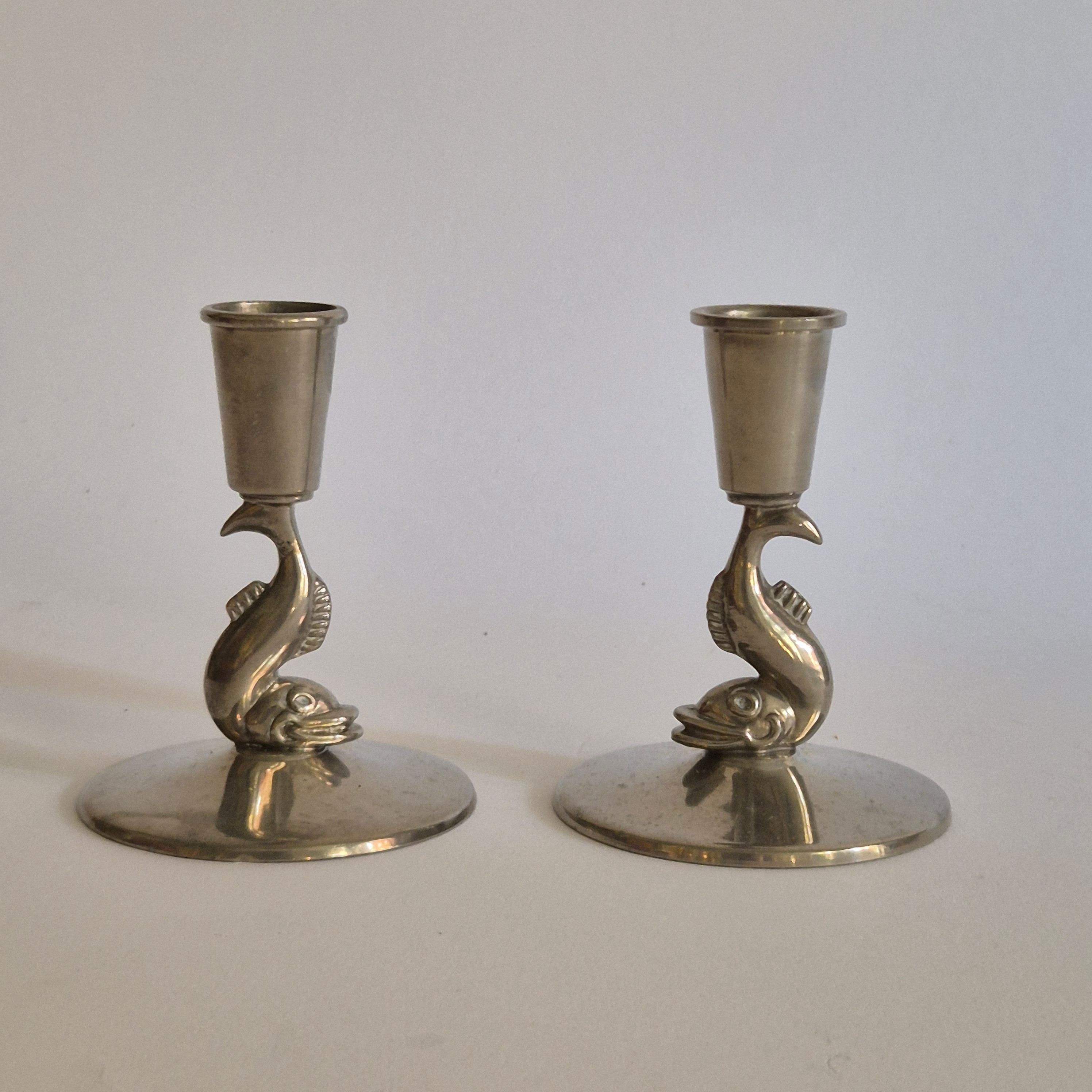 A pair of rare Swedish Grace candle holders in pewter by Ystad Tenn / Ystad Metall, 1930s. 

With decor of dolphin. 

In good condition, smaller signs of age and wear. 