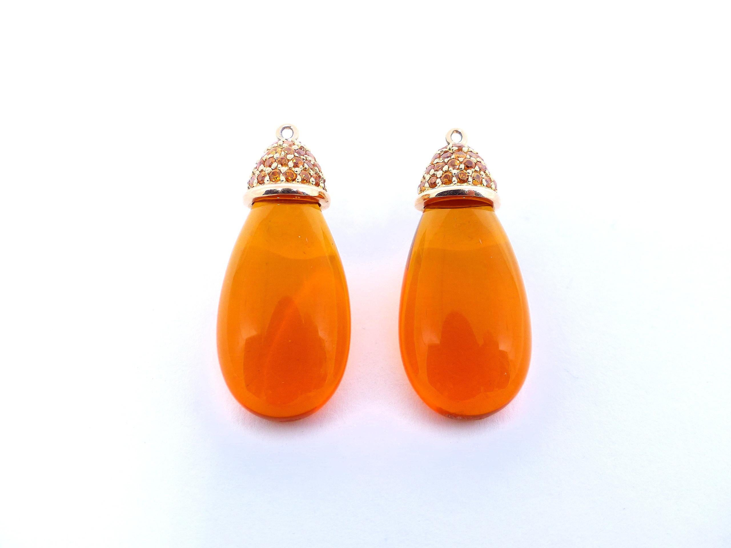 Thomas Leyser is renowned for his contemporary jewellery designs utilizing fine gemstones.

These 18k red gold (20g) earrings are set with 2x fine Mexican Fireopals in intensiv orange colour (briolette-cut, 25x13x8mm, 29.49ct) + 96x fine Mandarin