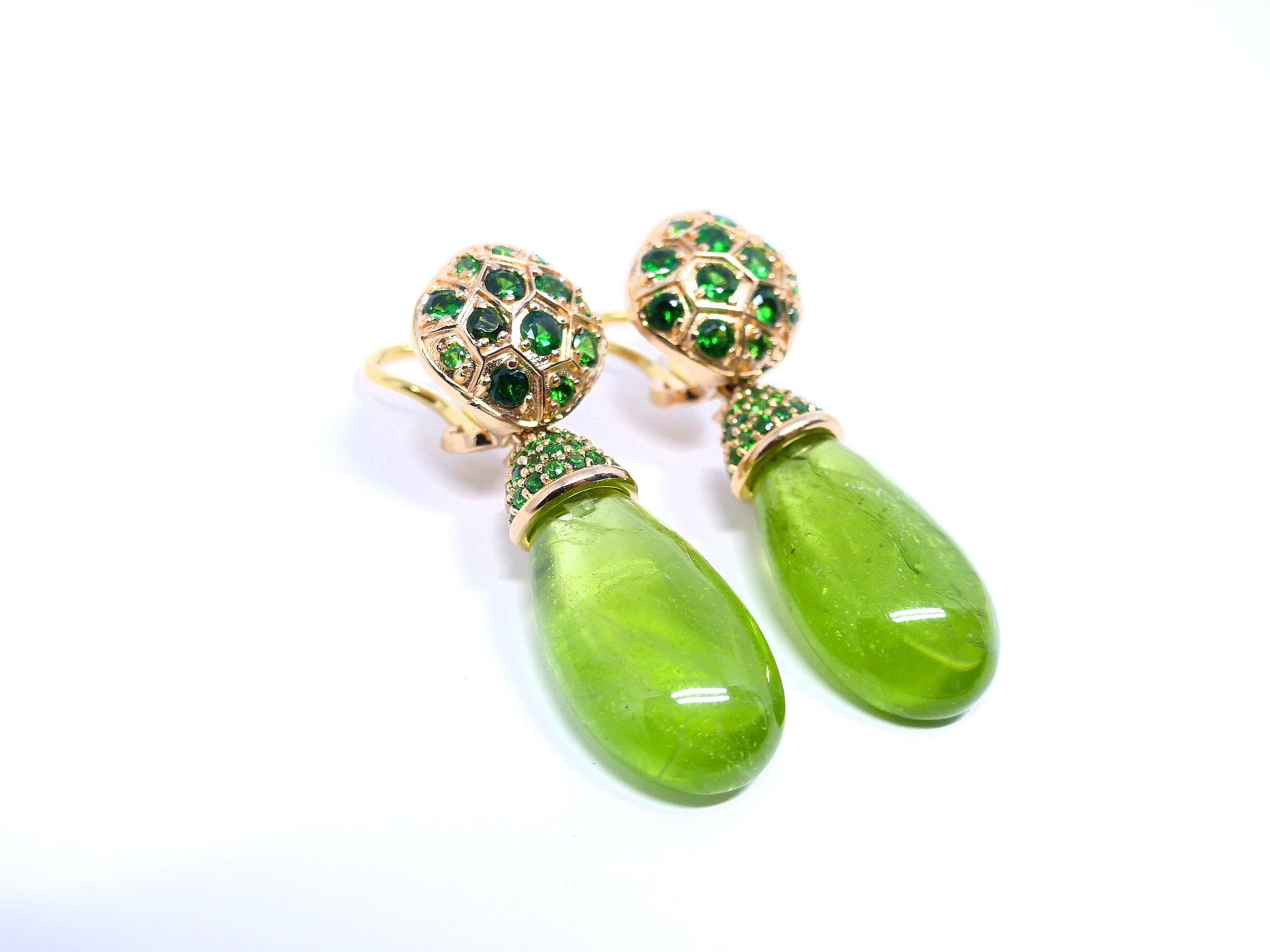 Thomas Leyser is renowned for his contemporary jewellery designs utilizing fine gemstones.

These 18k red gold (11.80g) pair of earrings are set with 2x fine Peridots in magnificient green colour (briolette-cut, 25x13x7.5mm, 42.19ct) + 96x