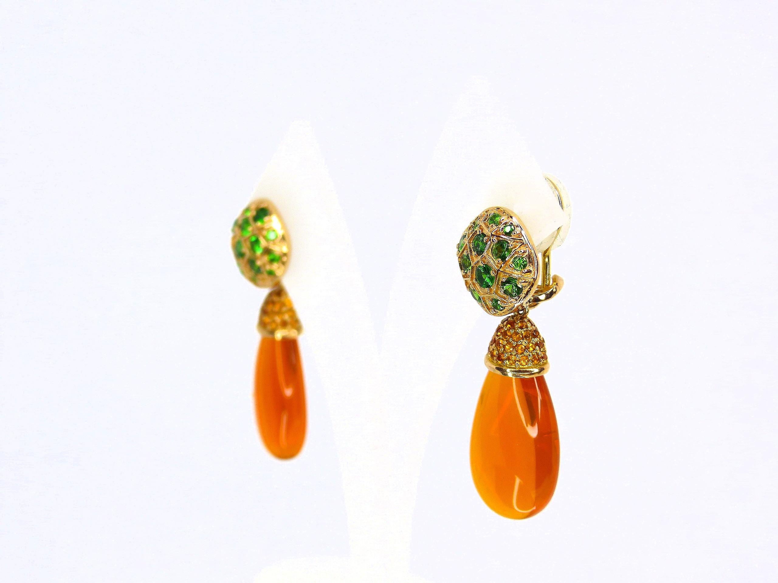 Thomas Leyser is renowned for his contemporary jewellery designs utilizing fine gemstones.

This 18k red gold (3.45g) pair of earrings is set with 2x fine Mexican Fireopal Brioletts (28x13x8mm, 29.49ct) + 70x Mandarin Garnets (round, 1.3mm, 0.70ct)