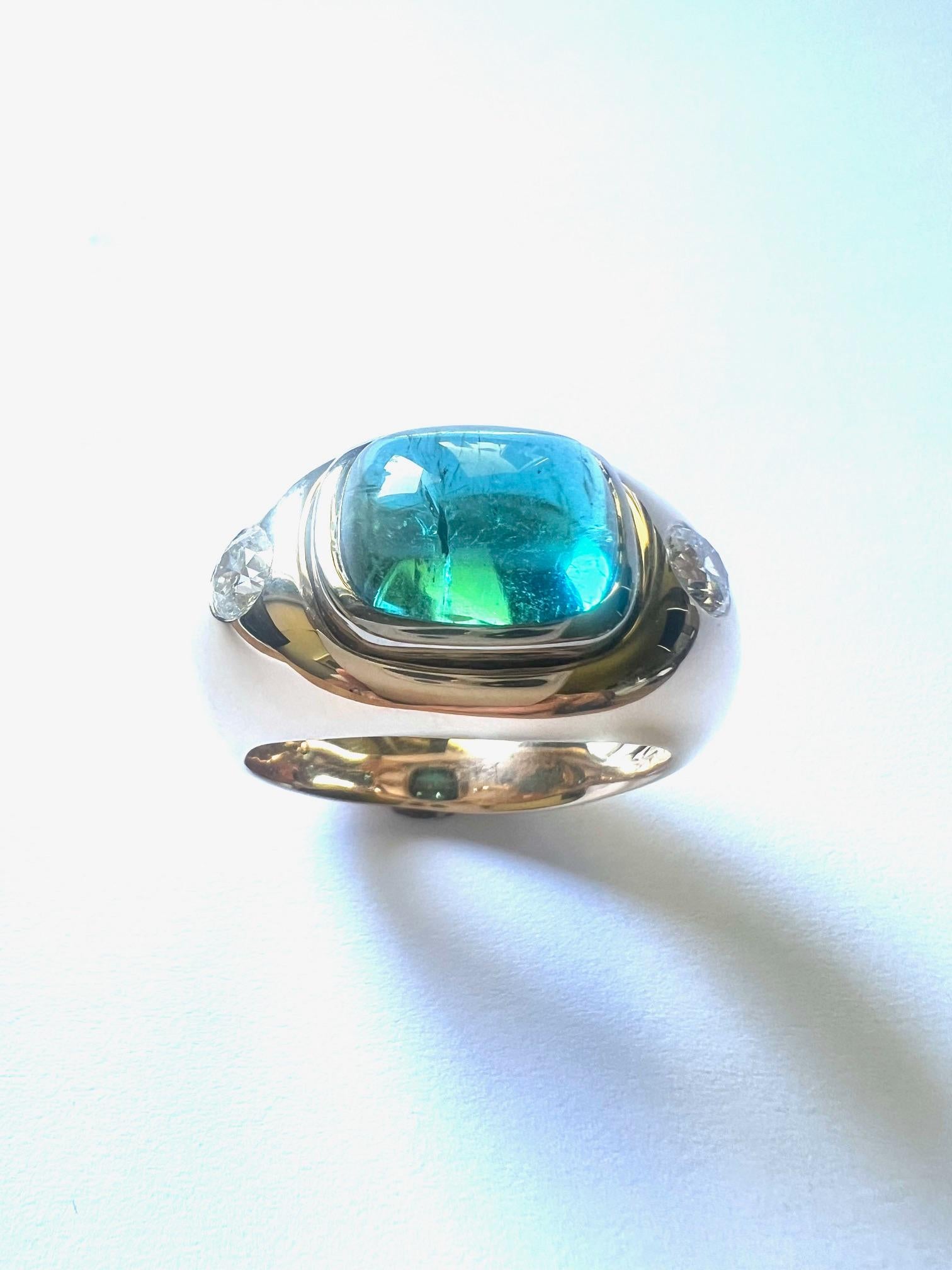 This 750/Rosé-+Whitegold ring is set with 1 Tourmaline Cabouchone, oval 12,7x10,8mm, 7,13cts. + 2 Diamonds G/VS, 0,95cts., round 4,5mm.
Ringsize is 69 and resizable.