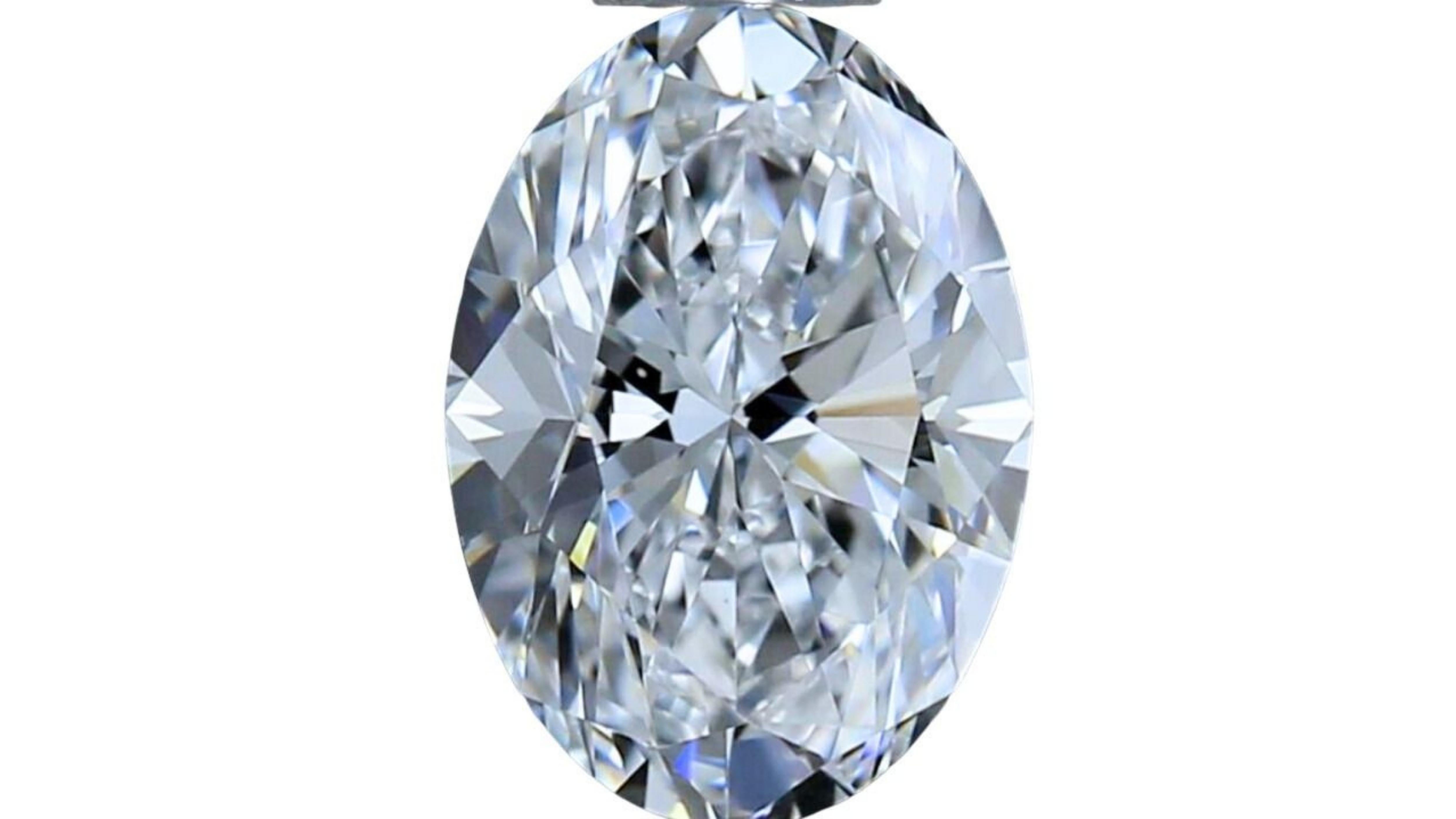 This stunning oval brilliant cut diamond is a rare and valuable gem. It is perfectly cut and polished to maximize its brilliance and sparkle. The color is D, the highest possible grade, and the clarity is VVS2, meaning that it has very few