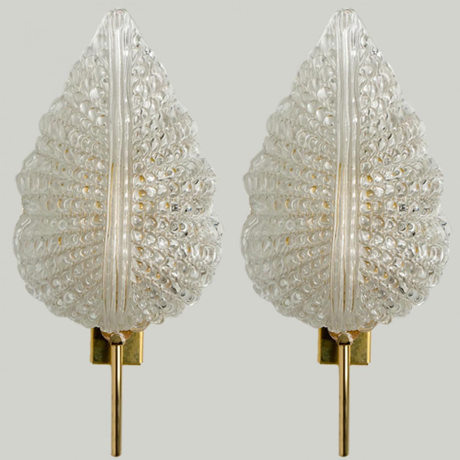1 of the 3 pairs of elegant and exquisite hand blown Murano glass in the style of Barovier &; Toso wall sconces with special gold inclusions. Each light fixture consists one blown Murano glass leave. Mounted on a brass frame. The leaves refract