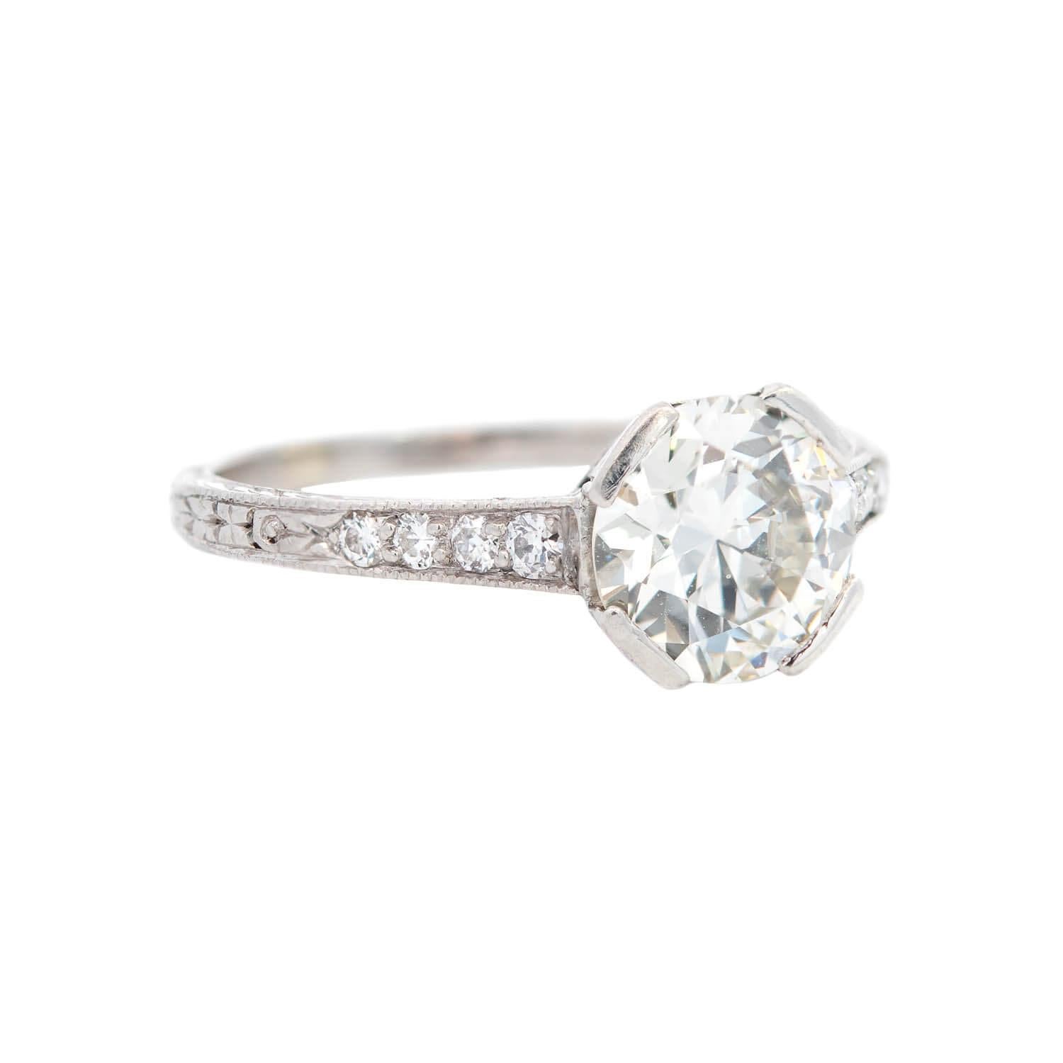 A simply breathtaking Tiffany & Co. engagement ring from the Art Deco (ca1930) era! Resting at the center of the platinum four bar claw mounting is a sparkling old European cut diamond. The center stone weighs approximately 1.25ct and is I/J color