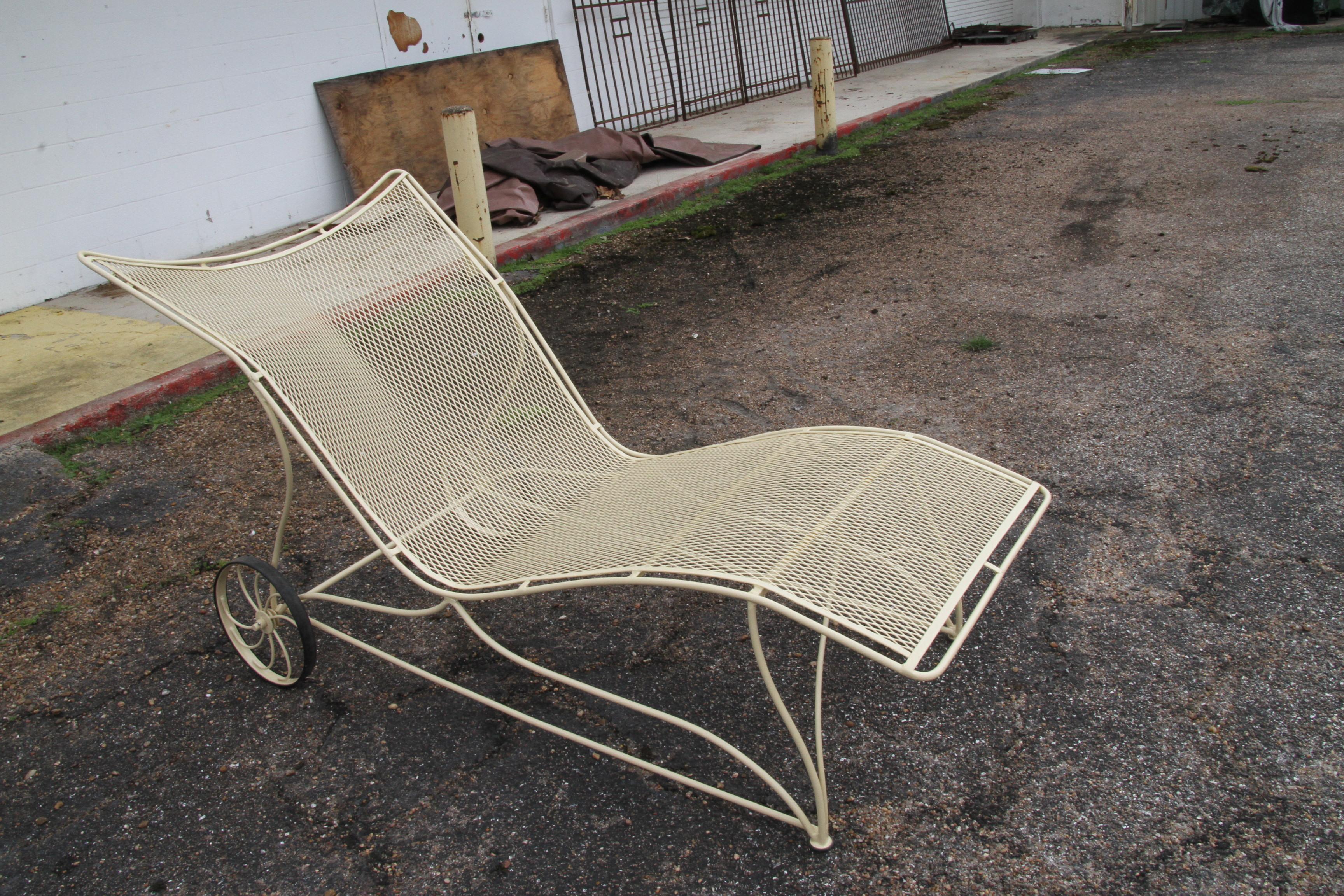 1 Vintage Russell woodard patio chaise

One oversized wrought iron chaise lounges featuring wide frames and wheels. Recently restored in rich buttercream. 
Measurements: 40.5