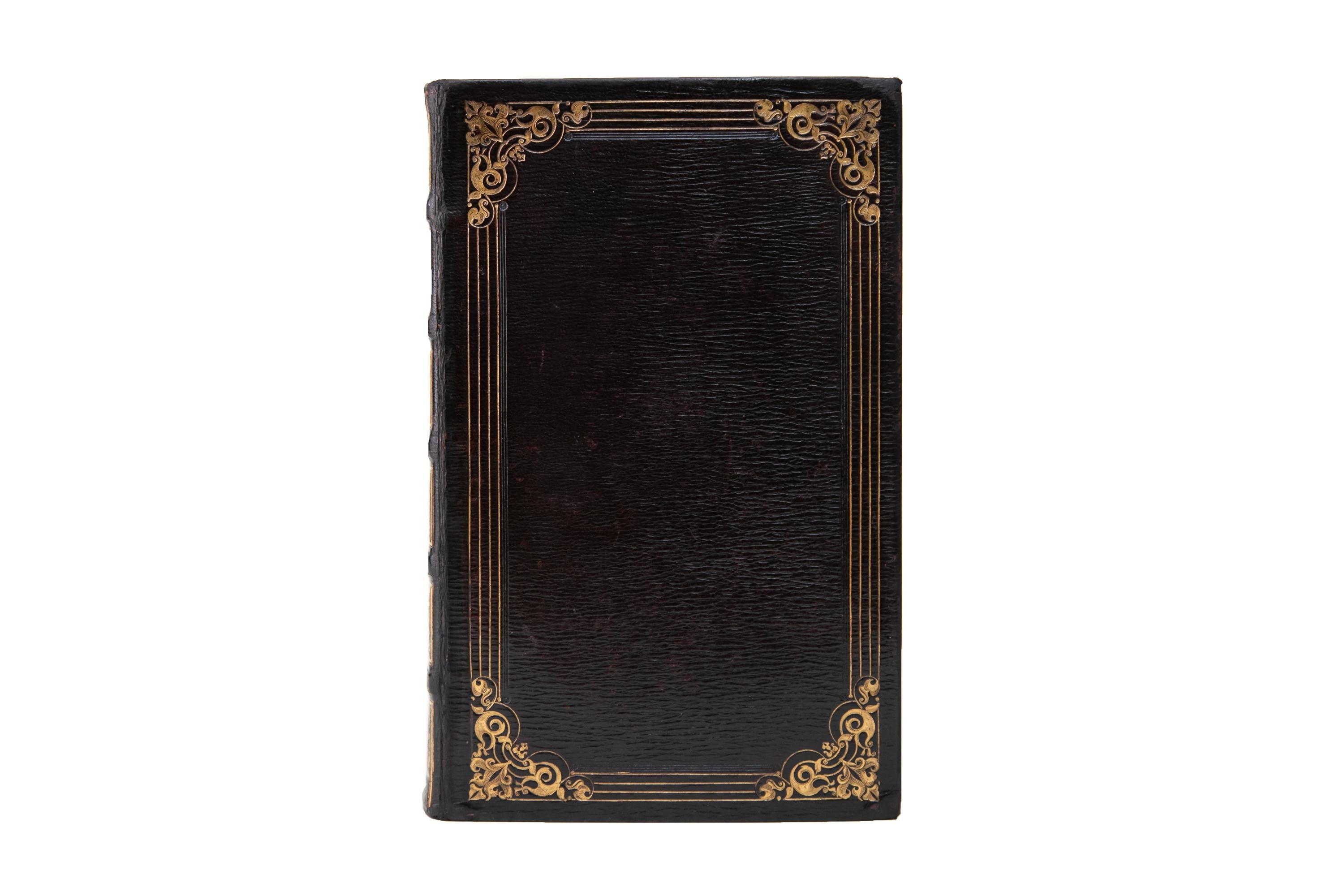 1 Volume. (Anon) The Book of Common Prayer. Bound in full purple morocco with the covers displaying bordering and floral corner flourishes, both gilt-tooled. All of the edges are gilded. Fore-edge painting. Published by The Clarendon Press in