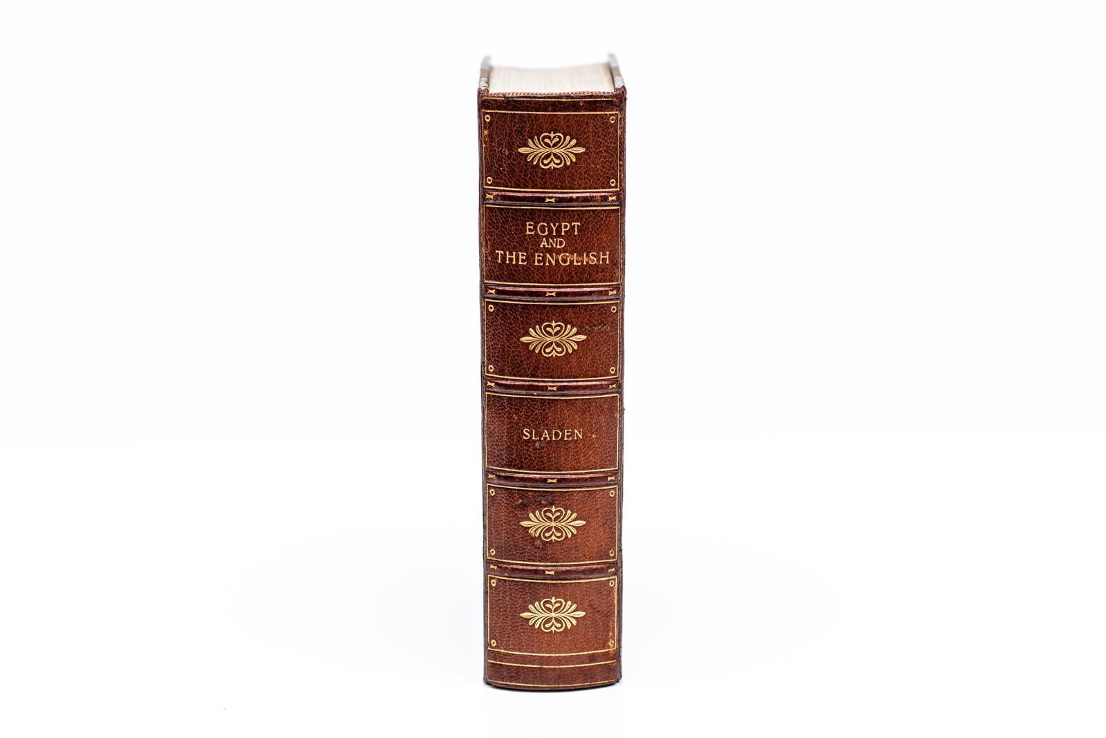 1 Volume. Douglas Sladen, Egypt & The English. Bound by Bayntun in 3/4 brown morocco and linen boards. The covers and raised band spine display gilt-tooling. The tp edge is gilt with marbled endpapers. Includes 40 illustrations. London: Hurst &