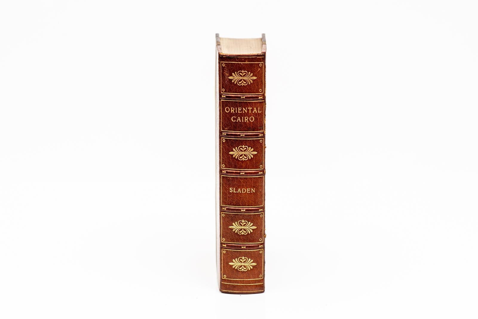 Bound by Baynton in 3/4 brown morocco and linen boards. The raised band spine and covers have gilt tooling. The top edge is gilt with marbled endpapers. 