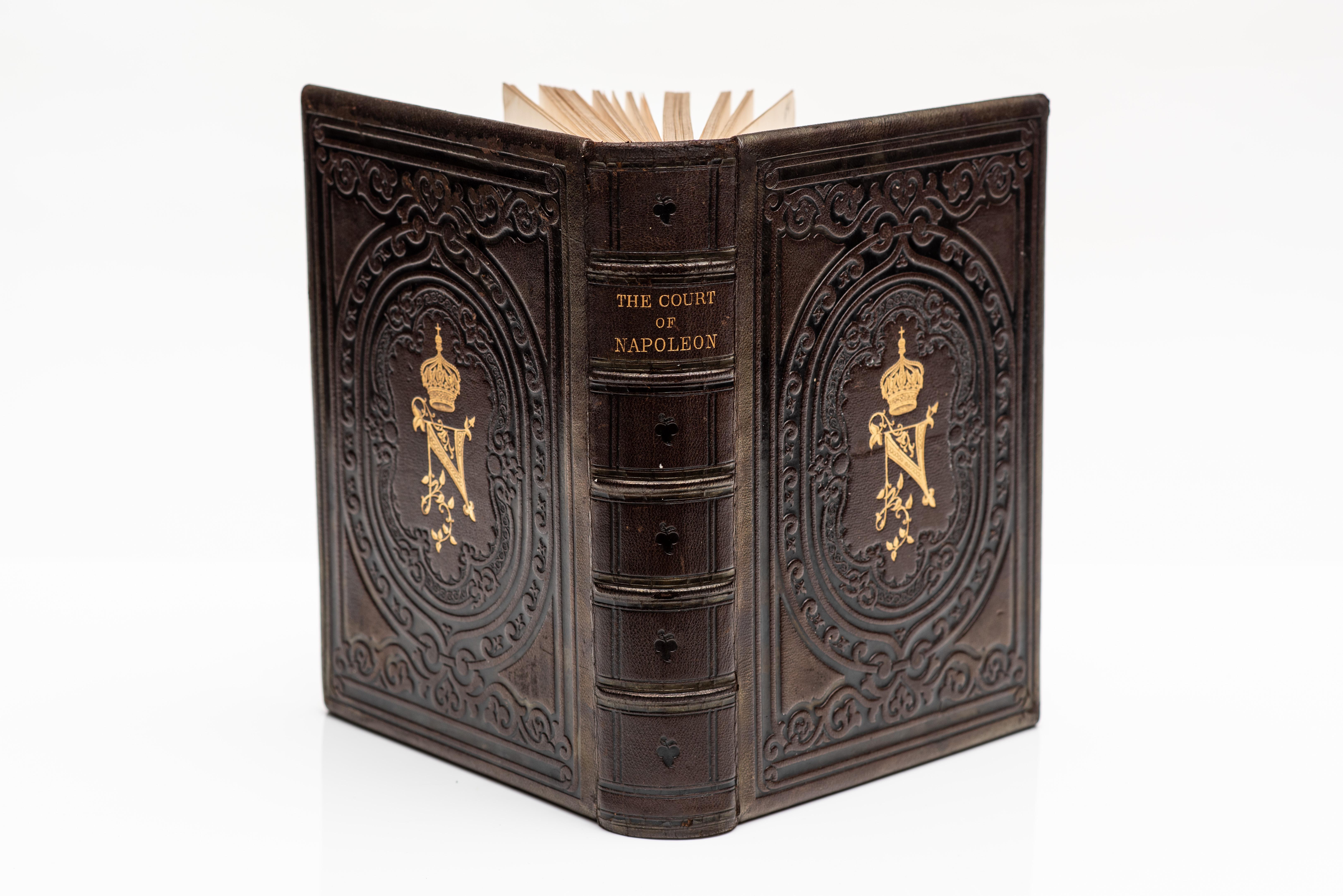 1 Volume. Goodrich, Frank B. The Court Of Napoleon. Illustrated in color by Jules Champagne. Bound in full brown morocco, all edges gilt, raised bands, blind tooling on covers and spine, gilt vignette on covers, marbled endpapers. Published: New