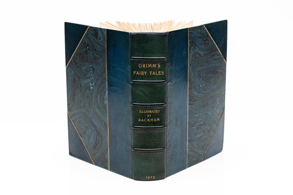 1 Volume. Jacob and Wilhelm Grimm, The Fairy Tales of the Brothers Grimm. First Edition illustrated by Arthur Rackham. Bound by Bayntun in 3/4 blue morocco with marbled boards. Gilt-tooling on covers and raised band spine. Top edge gilt. Color