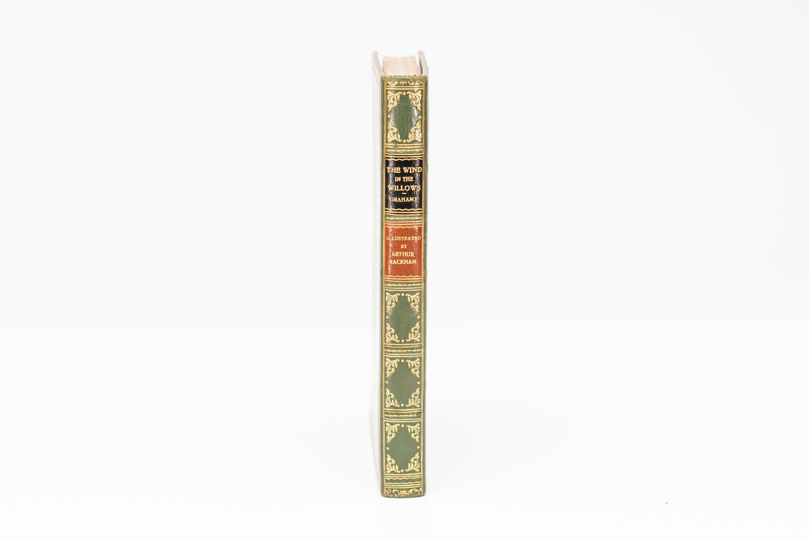 1 Volume. Kenneth Graham. Le vent dans les saules. Illustré par Arthur Rackham en couleurs. Reliure en plein veau vert poli, toutes les tranches dorées, bandes en relief, ornementation dorée au dos, trois caractères dorés au centre de la couverture