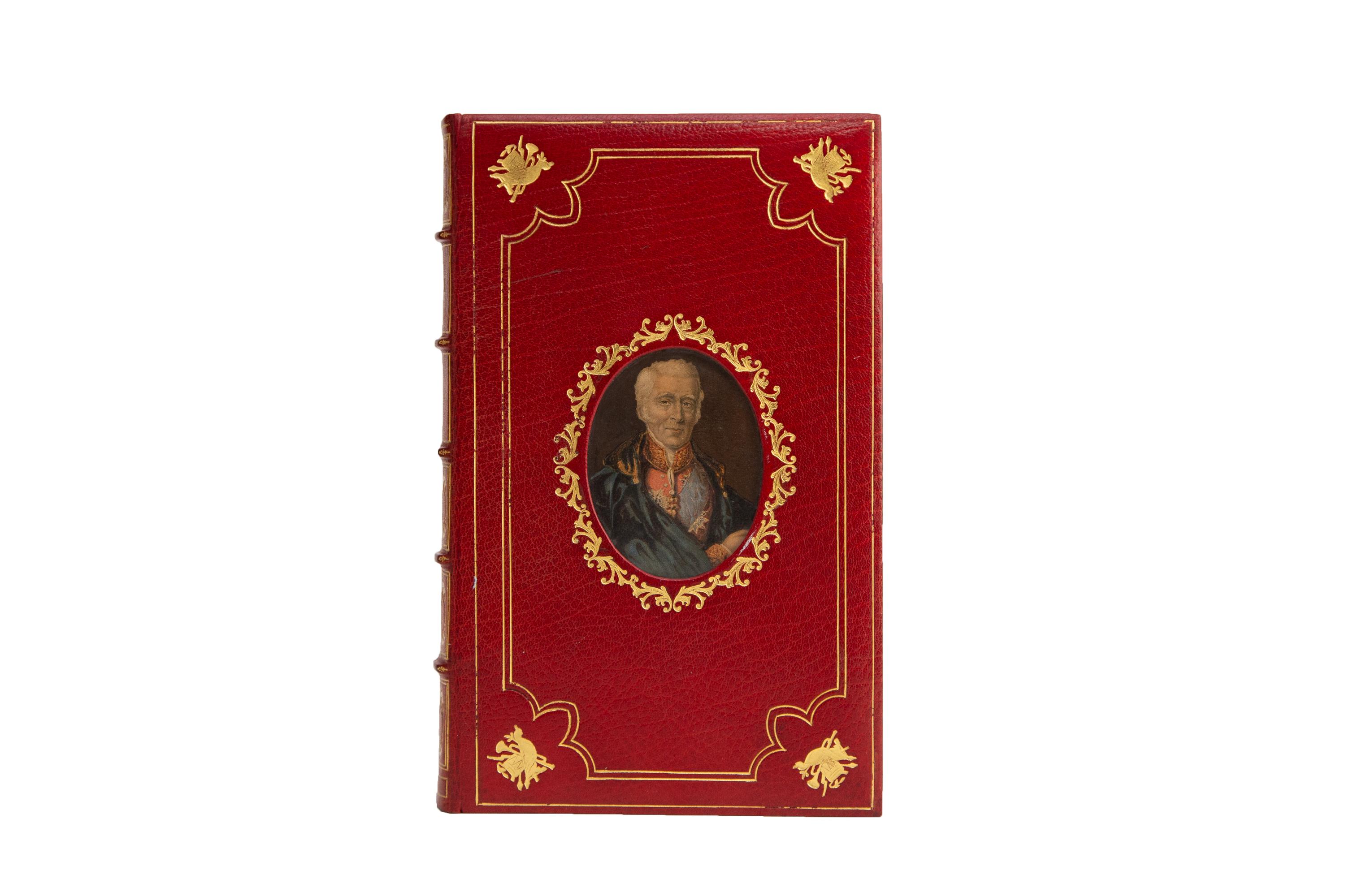 1 Volume. Philip Guedalla, The Duke. A Cosway-style binding by Bayntun. Bound in full red morocco with the front board displaying an insert portrait in color, bordered in a wreath of intricate tooling, and the front and back boards displaying gilt