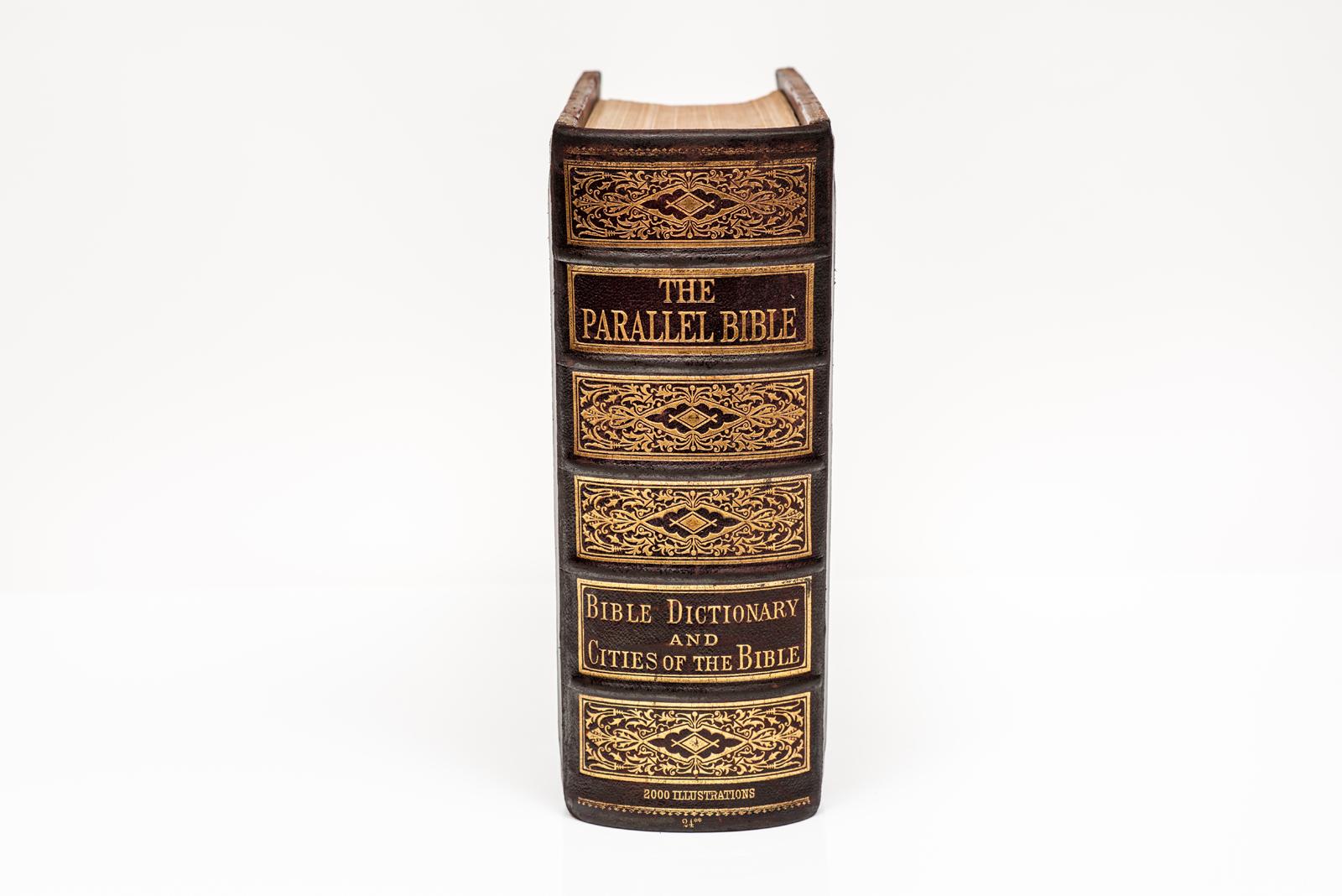 1 Volume. Alfred Nevin. The Holy Bible: Containing the Authorized and Revised Versions of the Old and New Testaments, Arranged in Parallel Columns. Bound in full brown morocco with ornate gilt-tooling on the covers and raised band spines with silver
