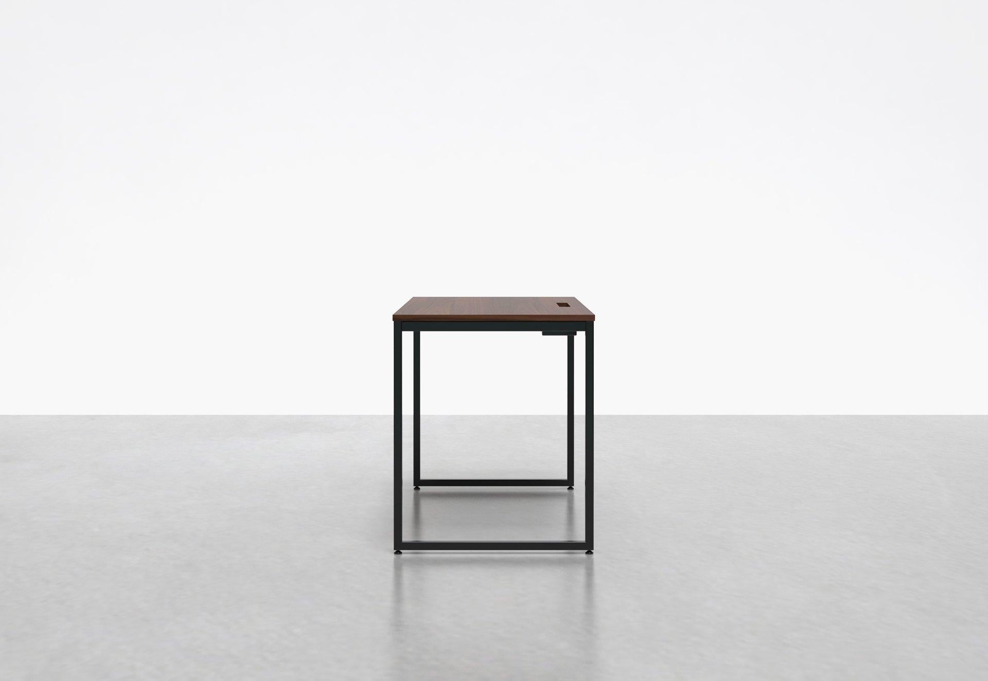 Inspired by the concept of an Architect's desk, our minimal 1 x 1 desk has box legs and is perfect in your home office or at the office. The 1 x 1 desk comes equipped with a built-in compartment that holds power-strips and helps conceal cables.