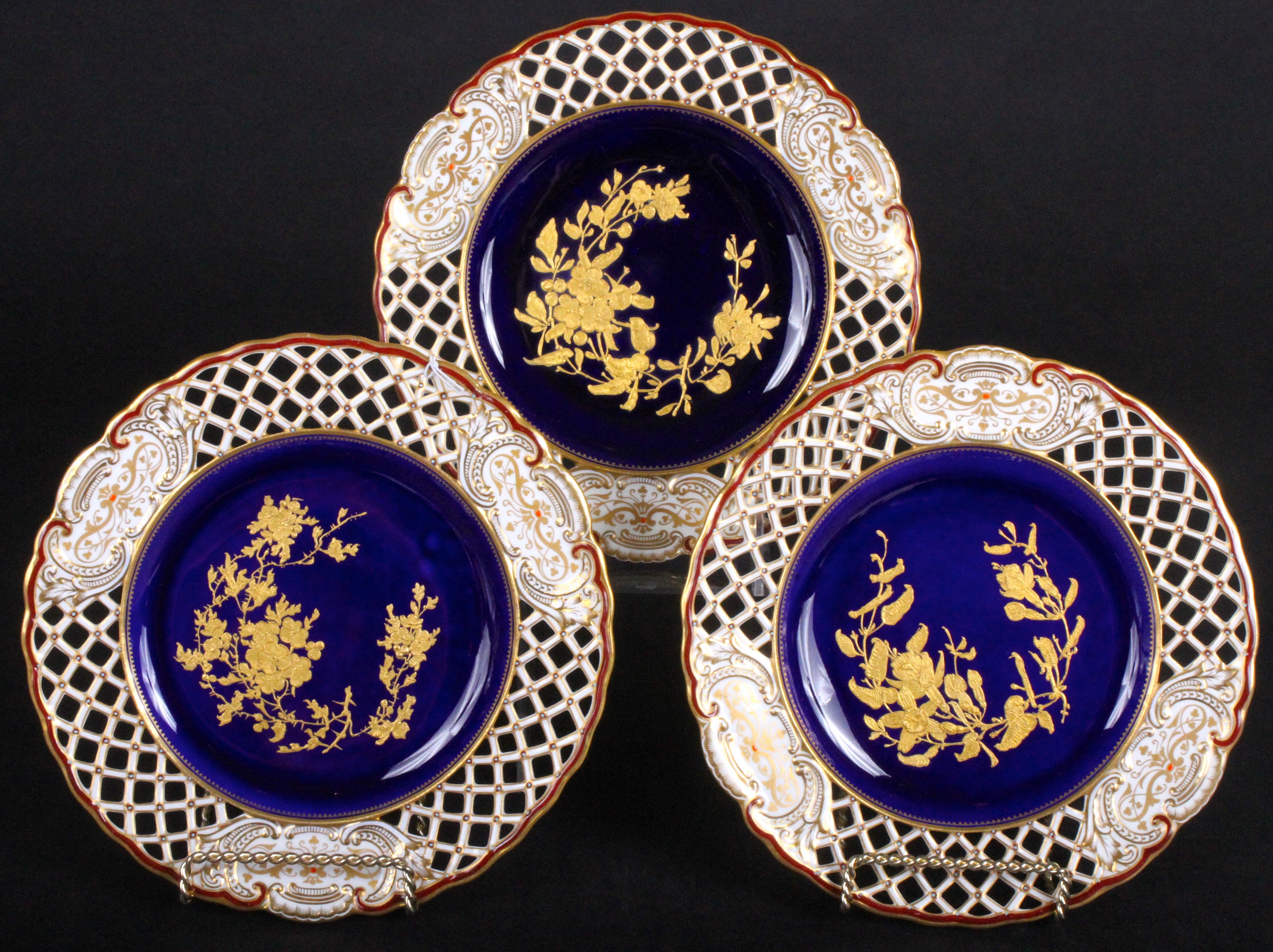 Here is a charming set of 10 reticulated 19th century Wedgwood queensware plates depicting naturalistic groupings of wildflowers rendered in great detail with tooled gold on cobalt ground. The rim of each plate features reticulation or piercing in a