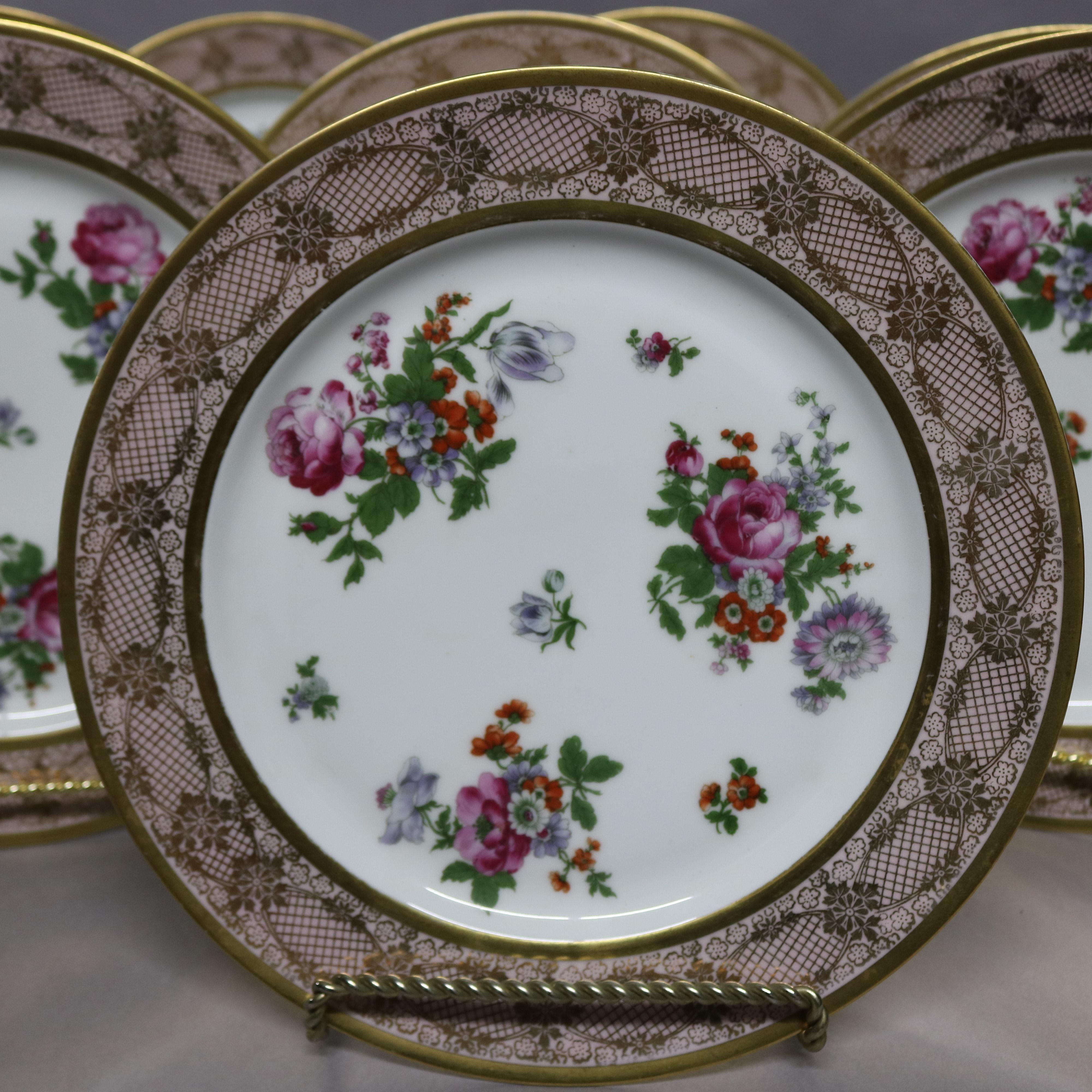 A set of 10 antique Bavarian porcelain dinner plates offer gilt lace and floral rims with wells having floral spray, en verso stamped 