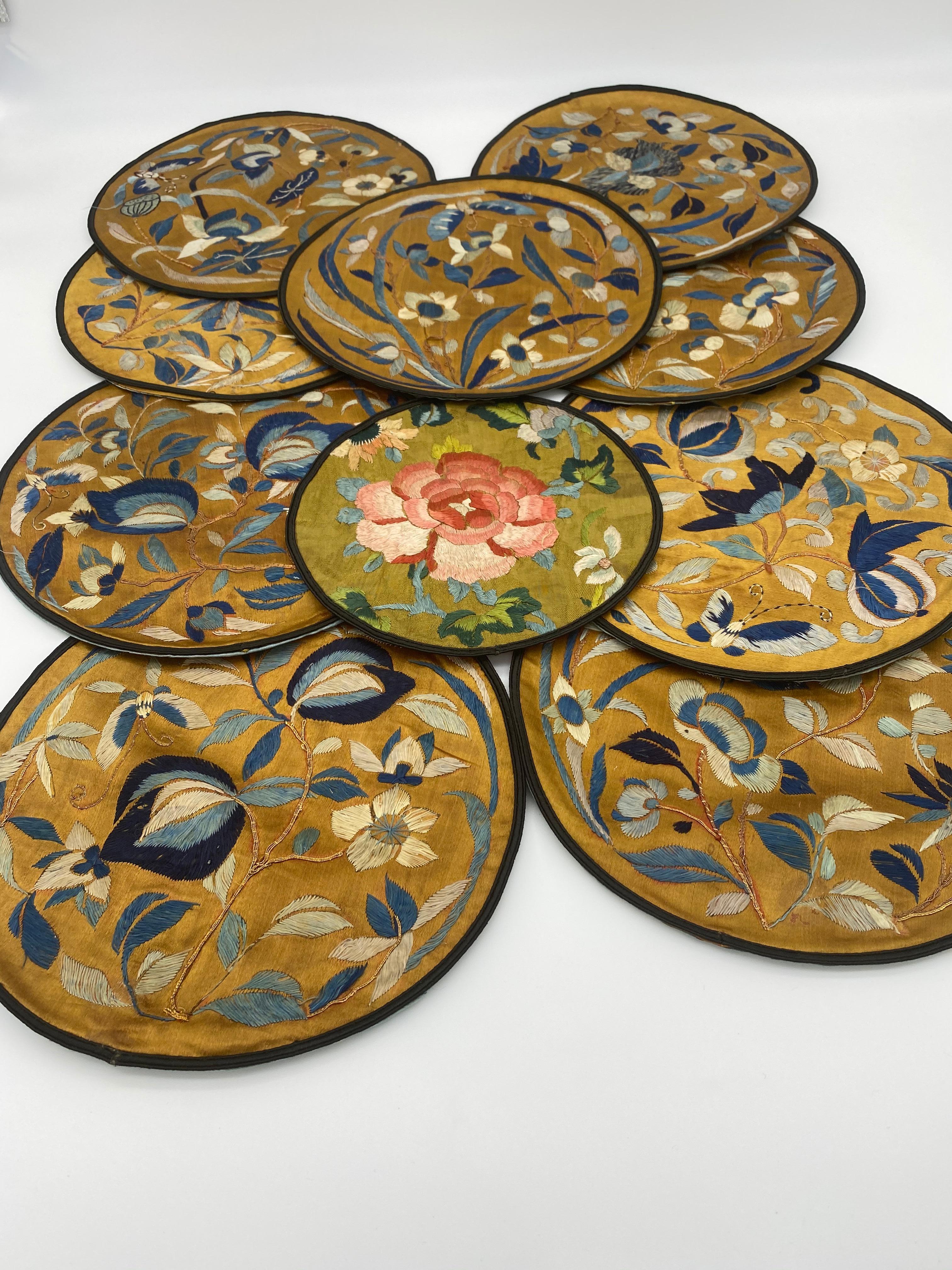 10 antique Qing Dynasty Chinese embroidered silk roundels embroidery robe. Decorated all-over with beautiful blue and red flowers. 9 pieces: 9 in diameter. 1 piece: 7 in diameter.
