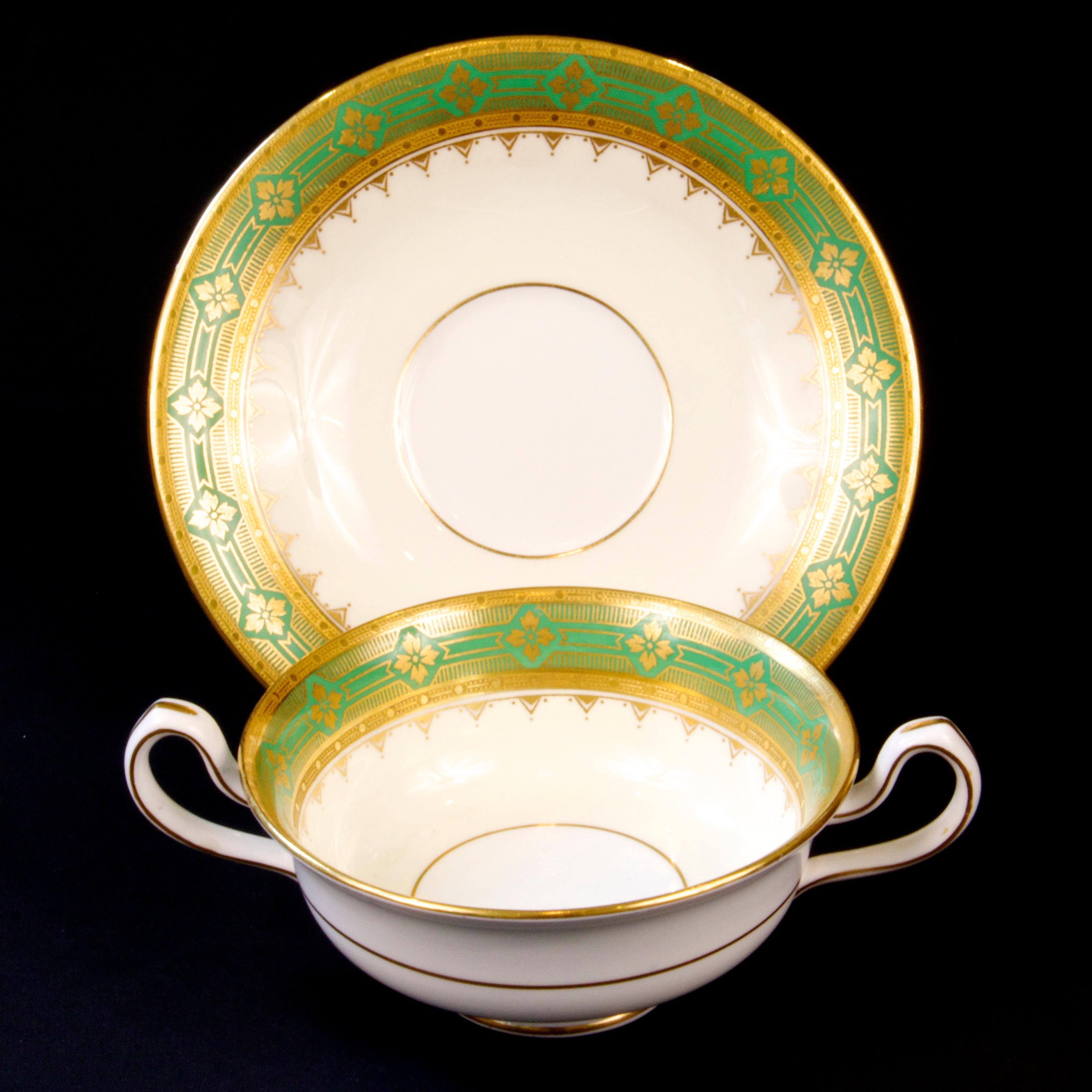 These 22-karat gold-encrusted cream soup or bullion cups from Minton, Stoke-on-Trent, England would make an elegant presentation at any dinner party. The design features gold quatrefoils motifs on green, finished by acid etched gold inner and outer