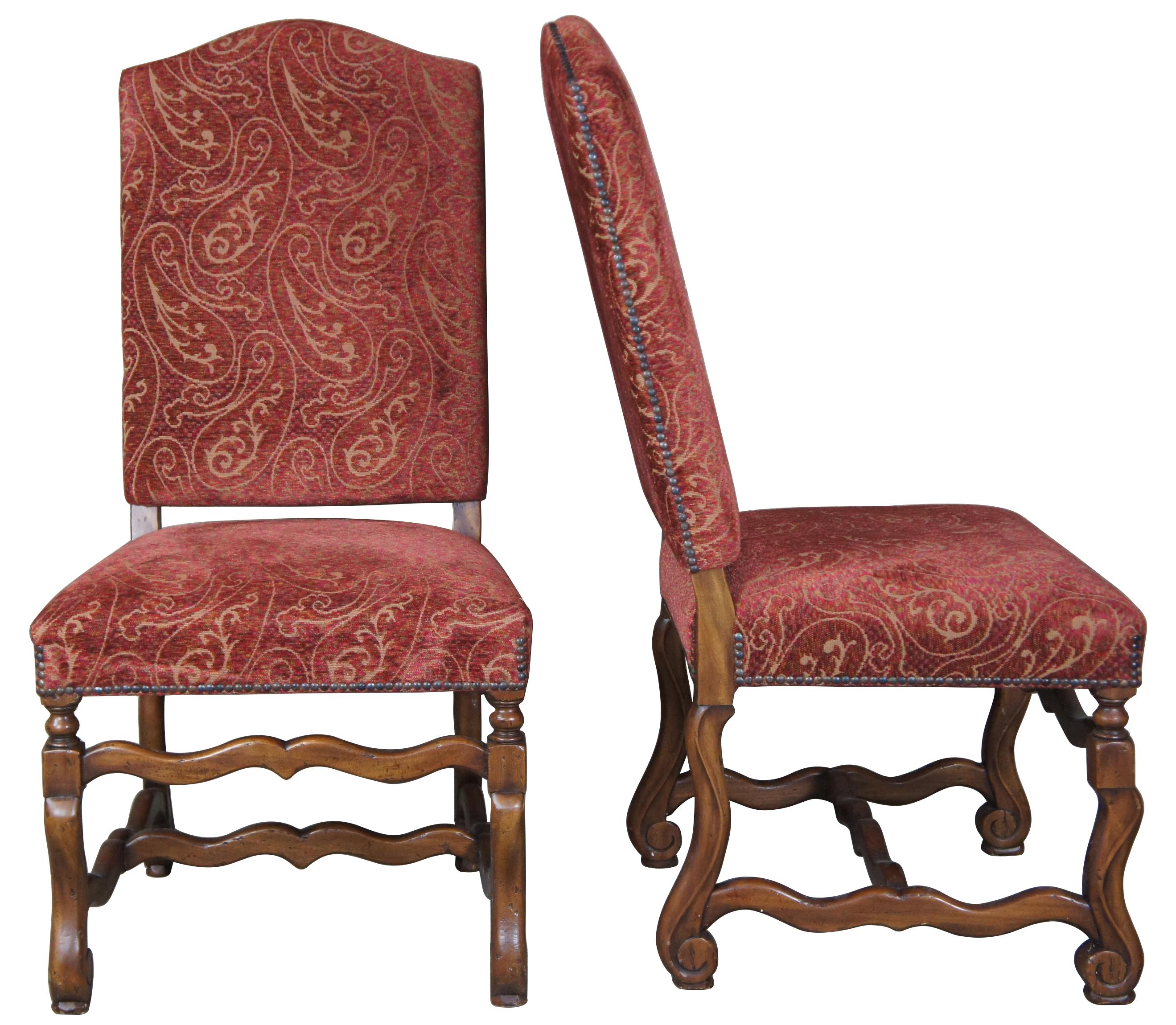 Set of ten Arte De Mexico style oak chairs. Features Tuscan / Spanish Revival or Louis XIII styling with a paisley upholstery accented with nailhead trim. Scrolled feet are connected by serpentine H-stretcher.
 