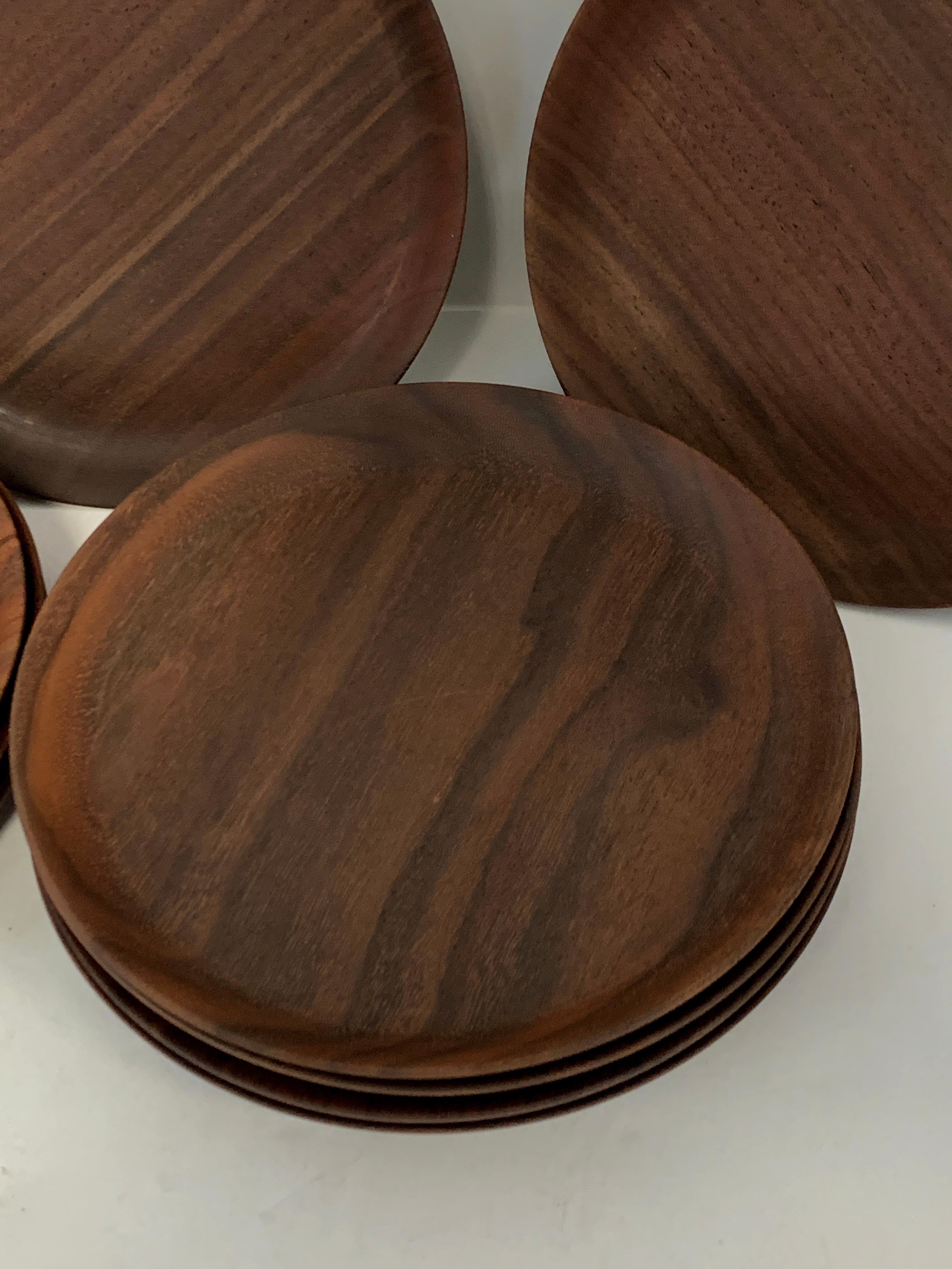 A set of 10 handmade plates in black walnut by the noted California woodworker Bob Stocksdale. They are approximate 6.75 inches in diameter and marked black walnut from California Bob Stocksdale 1985. They feature nice graining. They are in good age