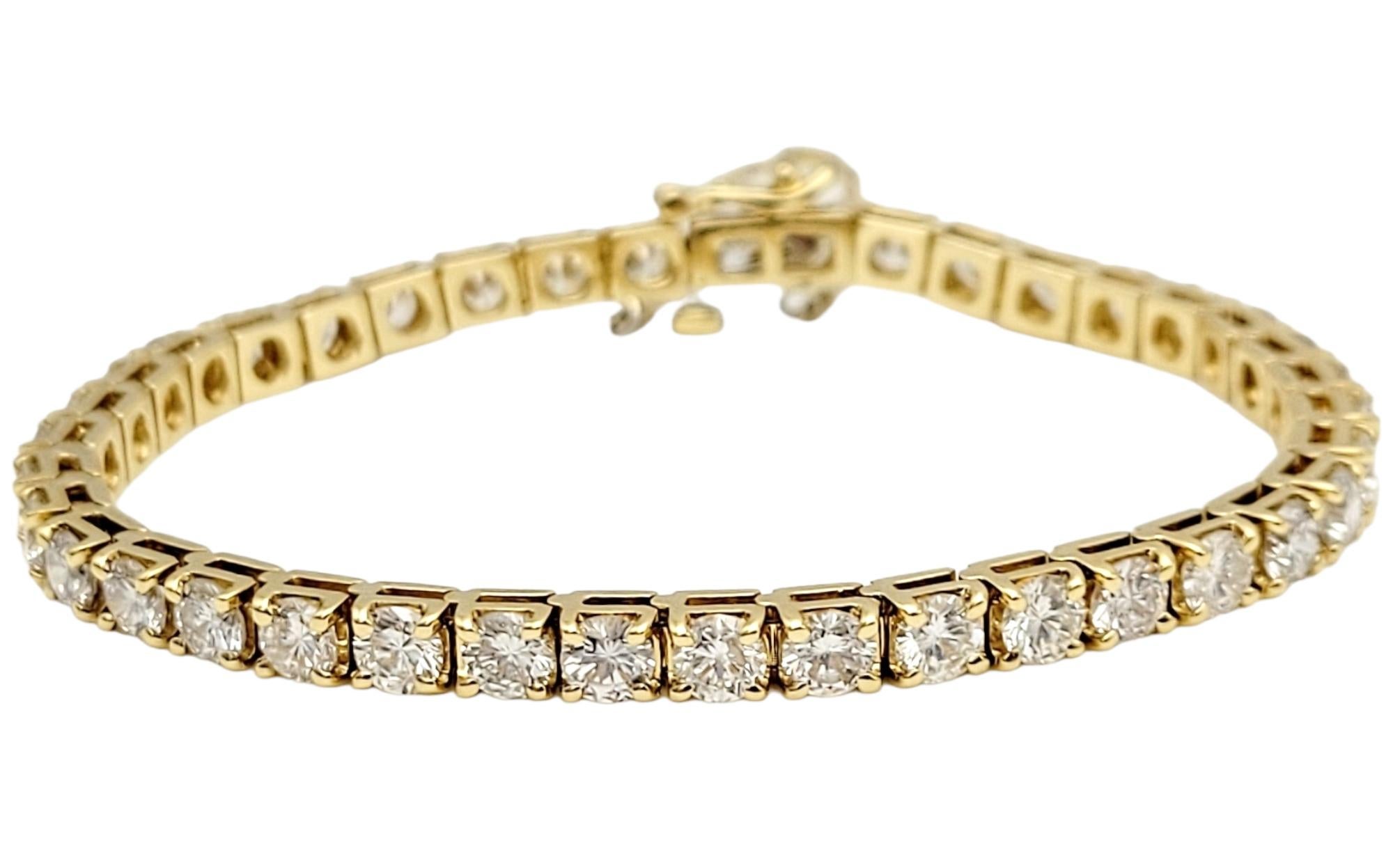 Introducing an exquisite 10-carat round brilliant cut diamond tennis bracelet, elegantly crafted in lustrous 18-karat yellow gold. This captivating piece showcases a mesmerizing array of 39 round brilliant cut diamonds weighing 10 carats. With a