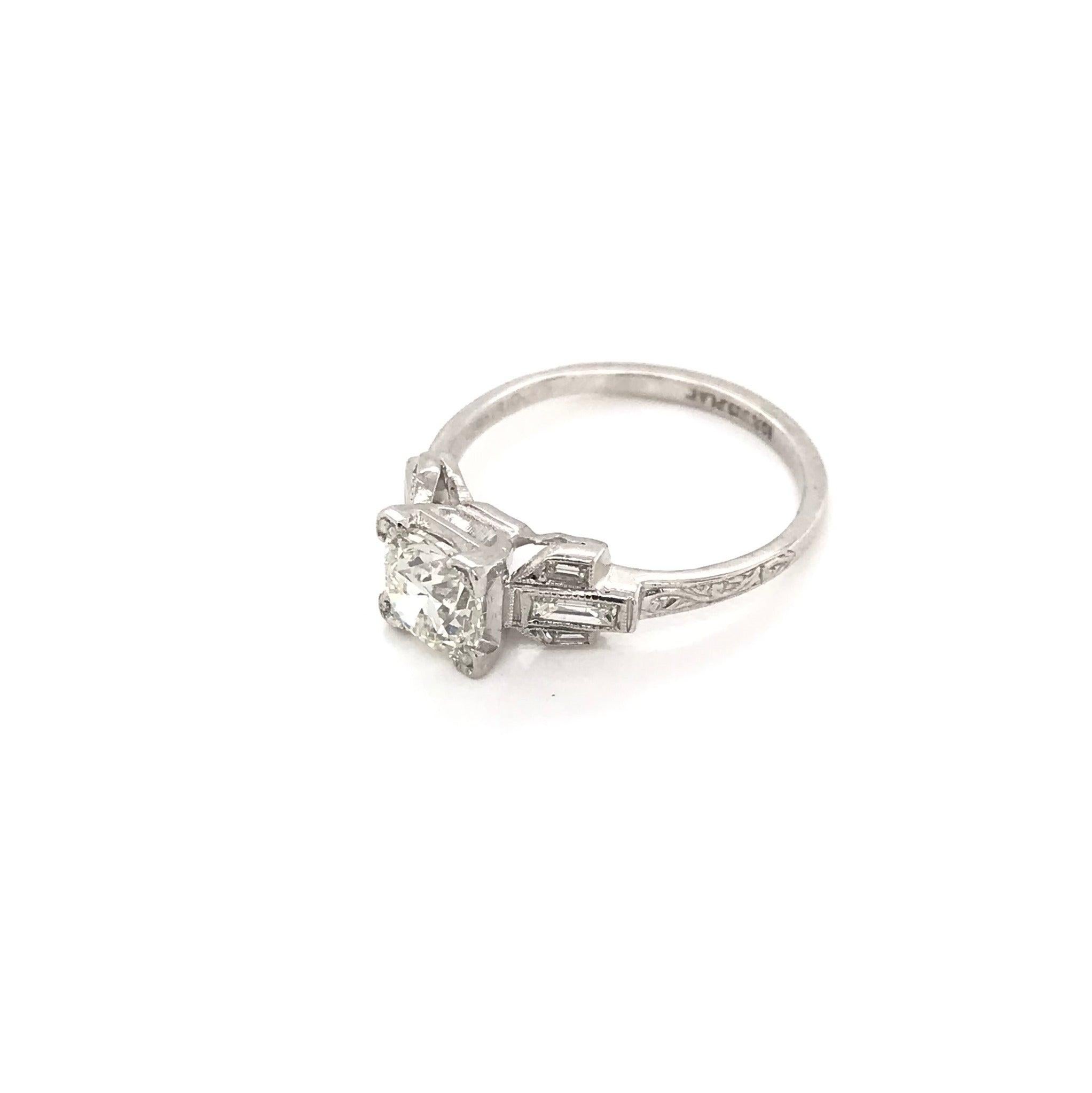 This gorgeous antique piece was handcrafted during the Art Deco design period ( 1920-1940 ). The ring features a fiery 1.0 carat center diamond. The center diamond grades approximately J in color, VS2 in clarity. This charming piece also features